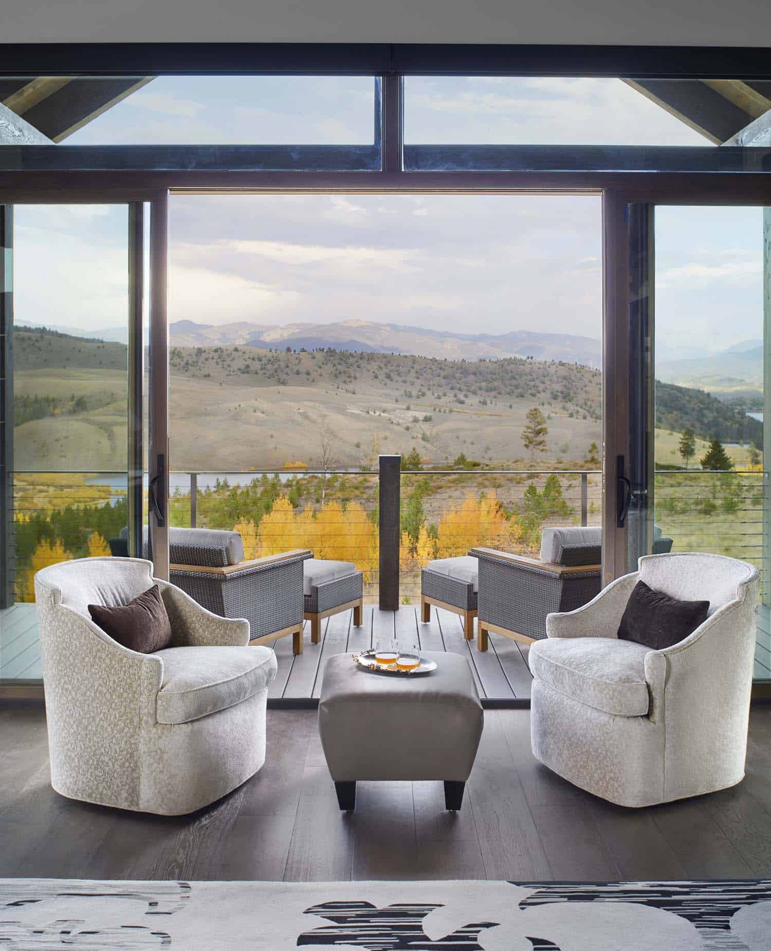contemporary living room with a large window and mountain views