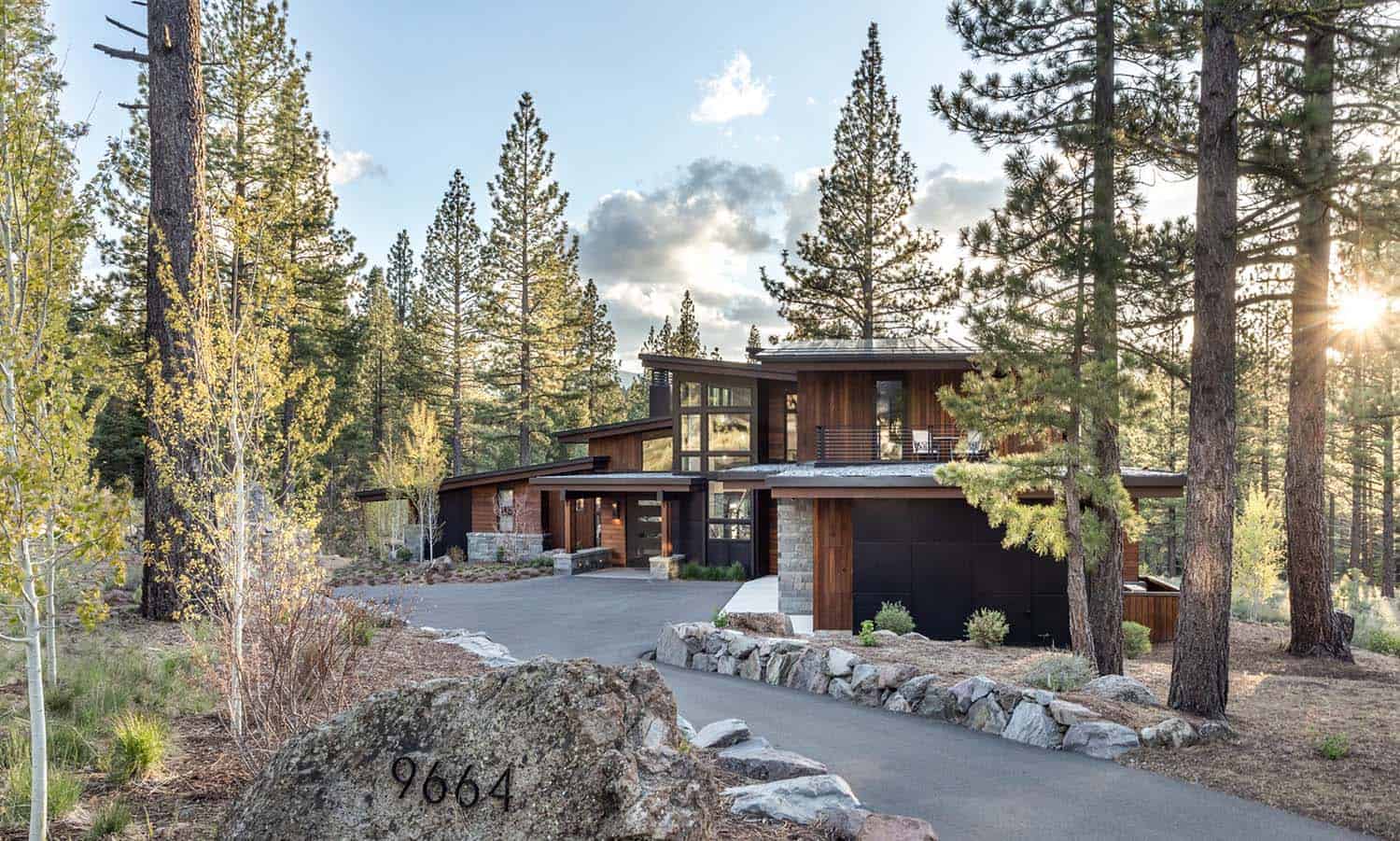 modern mountain home exterior with a long driveway