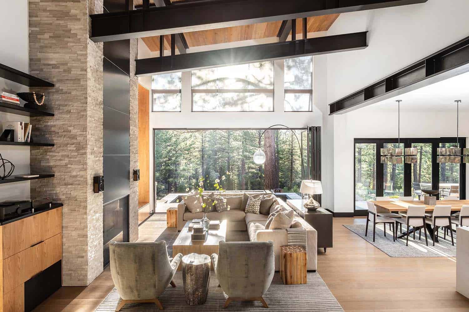 modern living room with a floor-to-ceiling fireplace and large window views