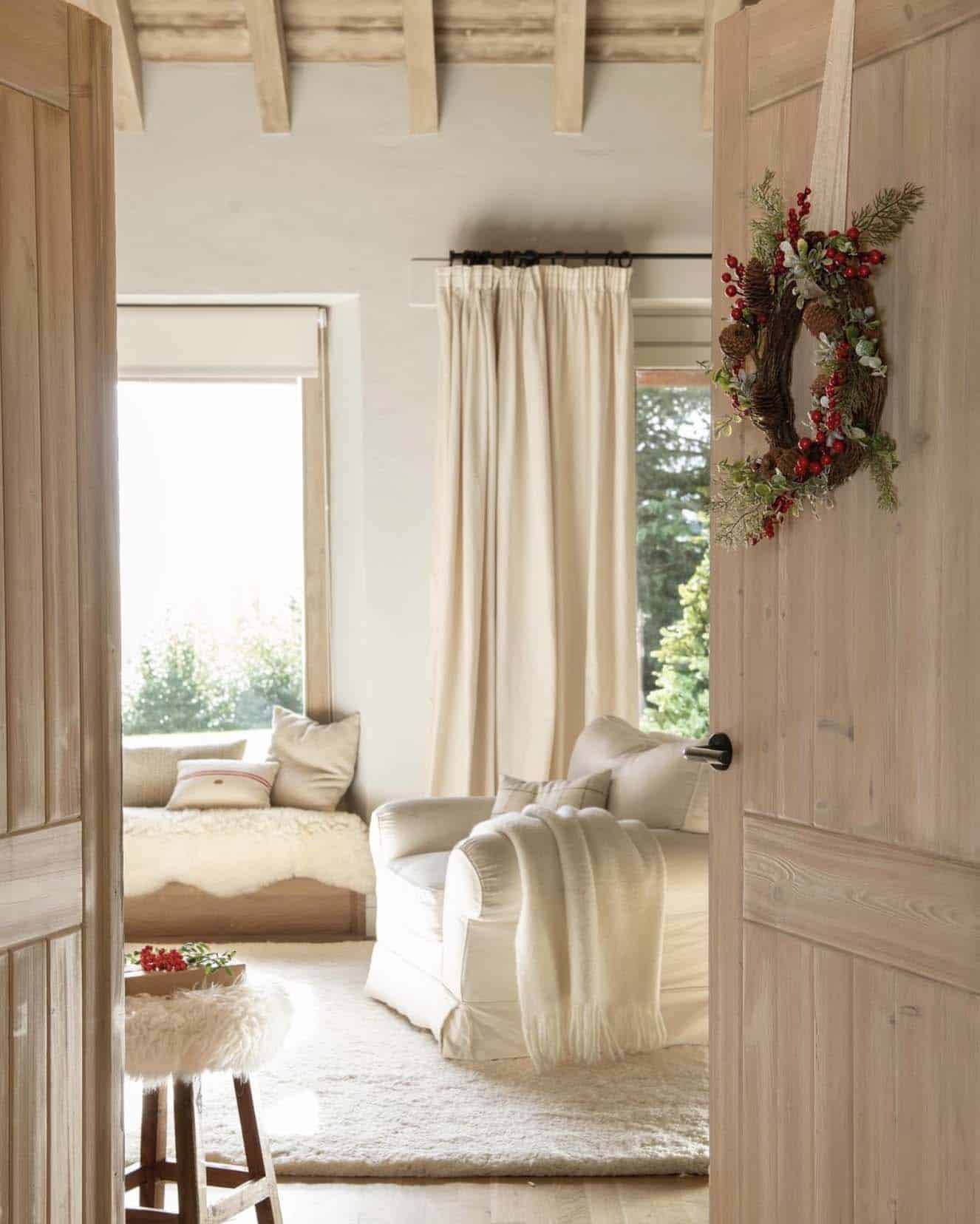 rustic family room with a christmas wreath on the door