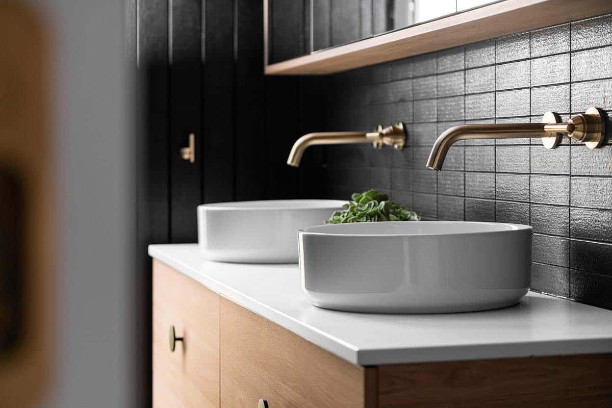 Scandinavian style bathroom vanity with black tiles
