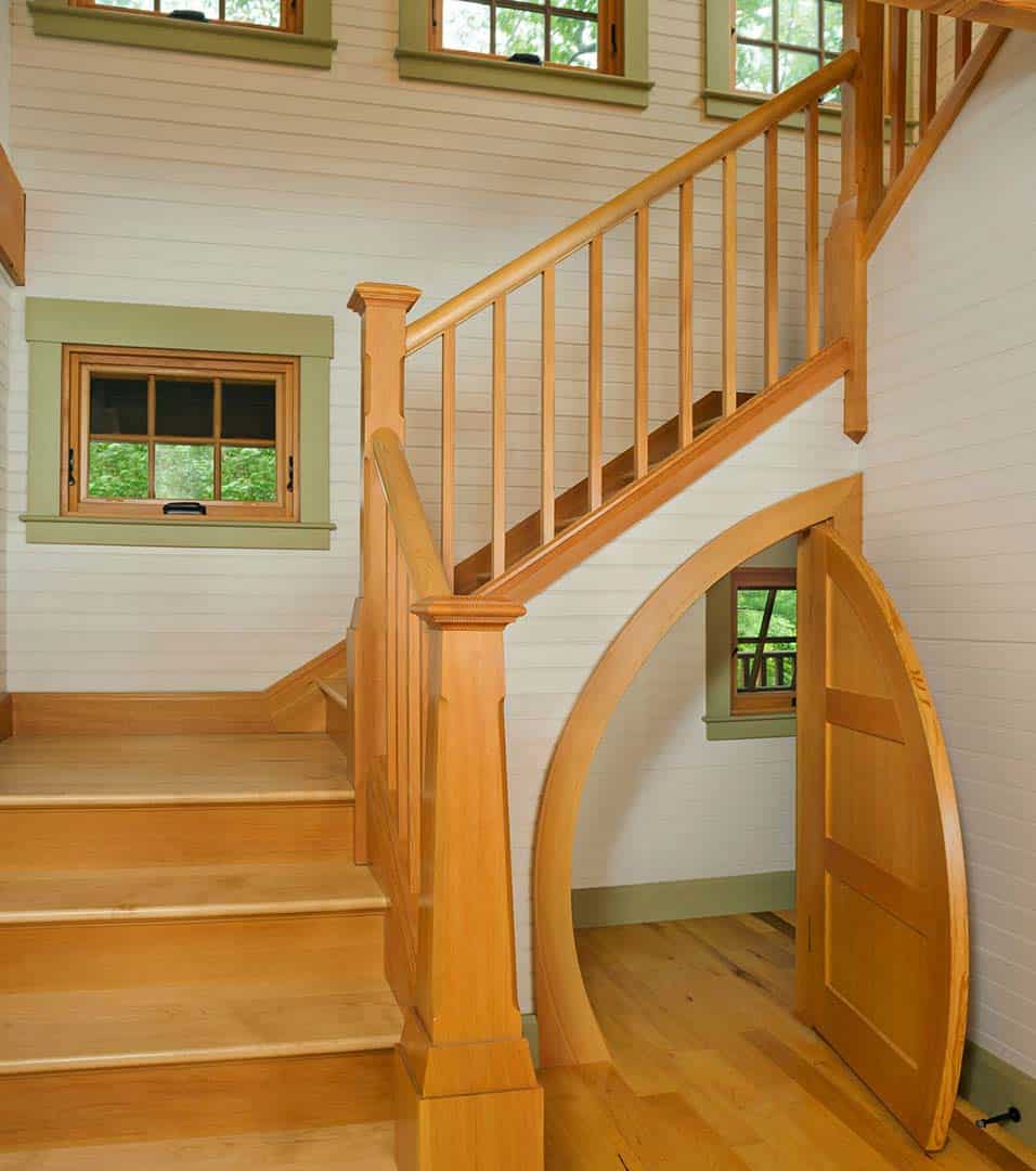 rustic staircase with a hobbit door