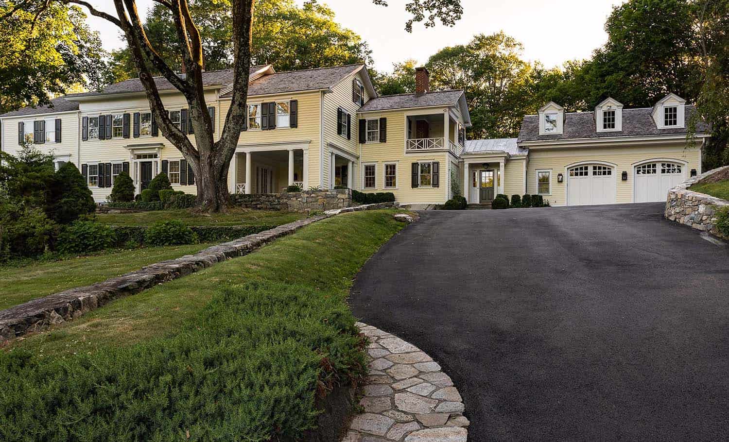 transitional style country home exterior with a long driveway