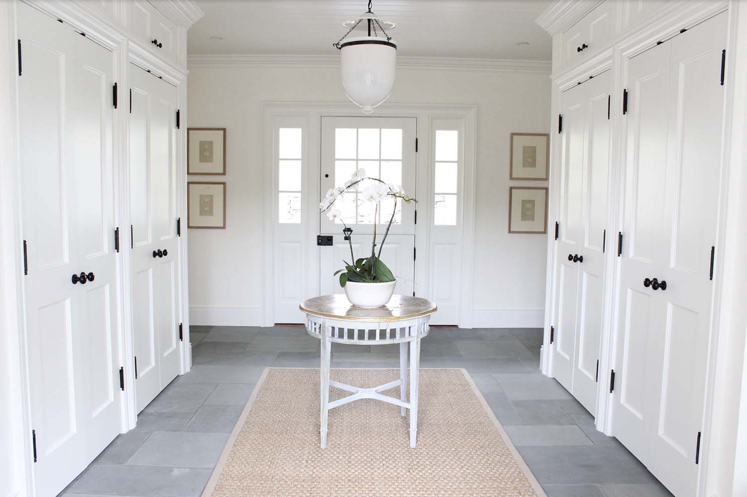 transitional style mudroom entry with a small table