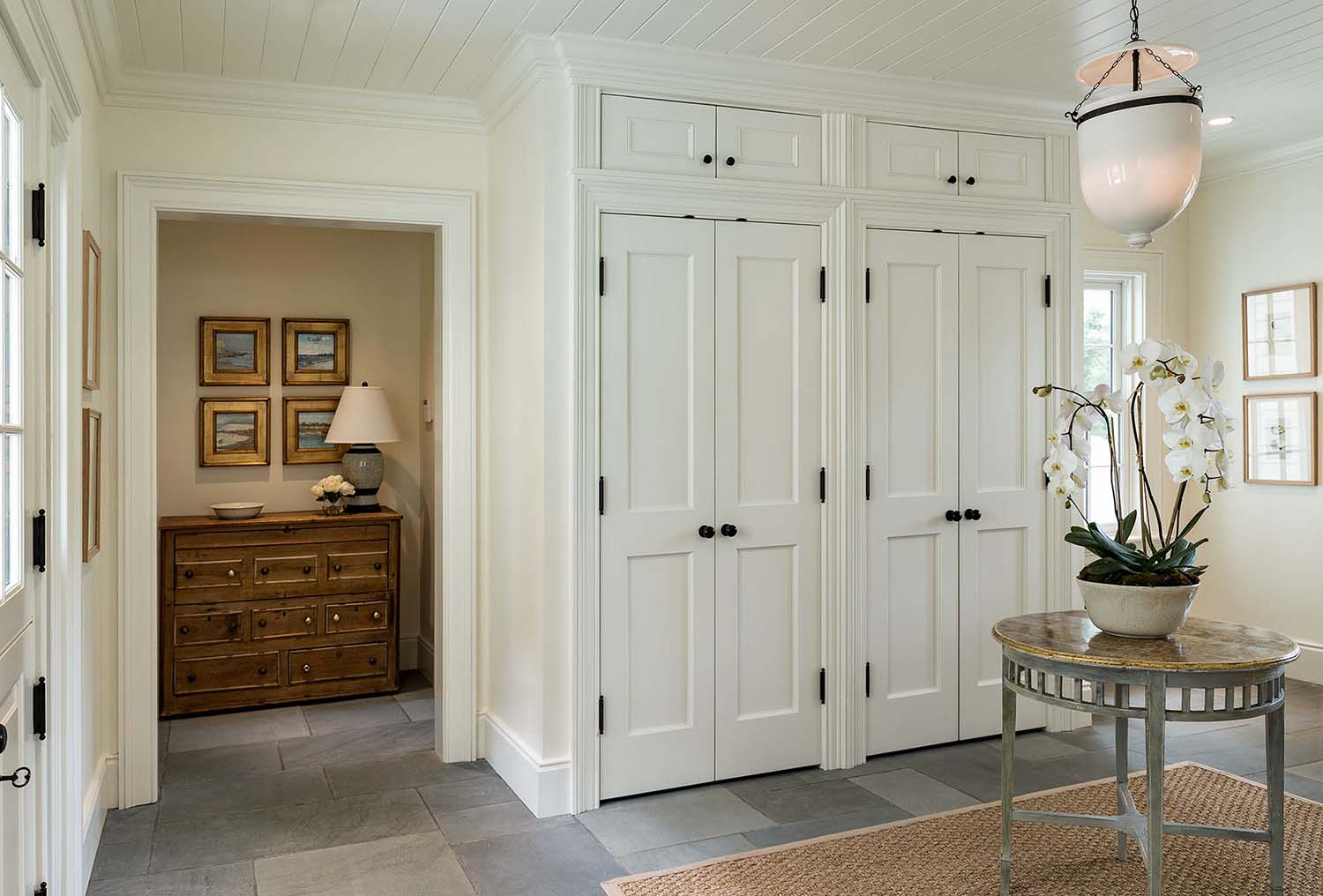 transitional style home entry with built-in closets