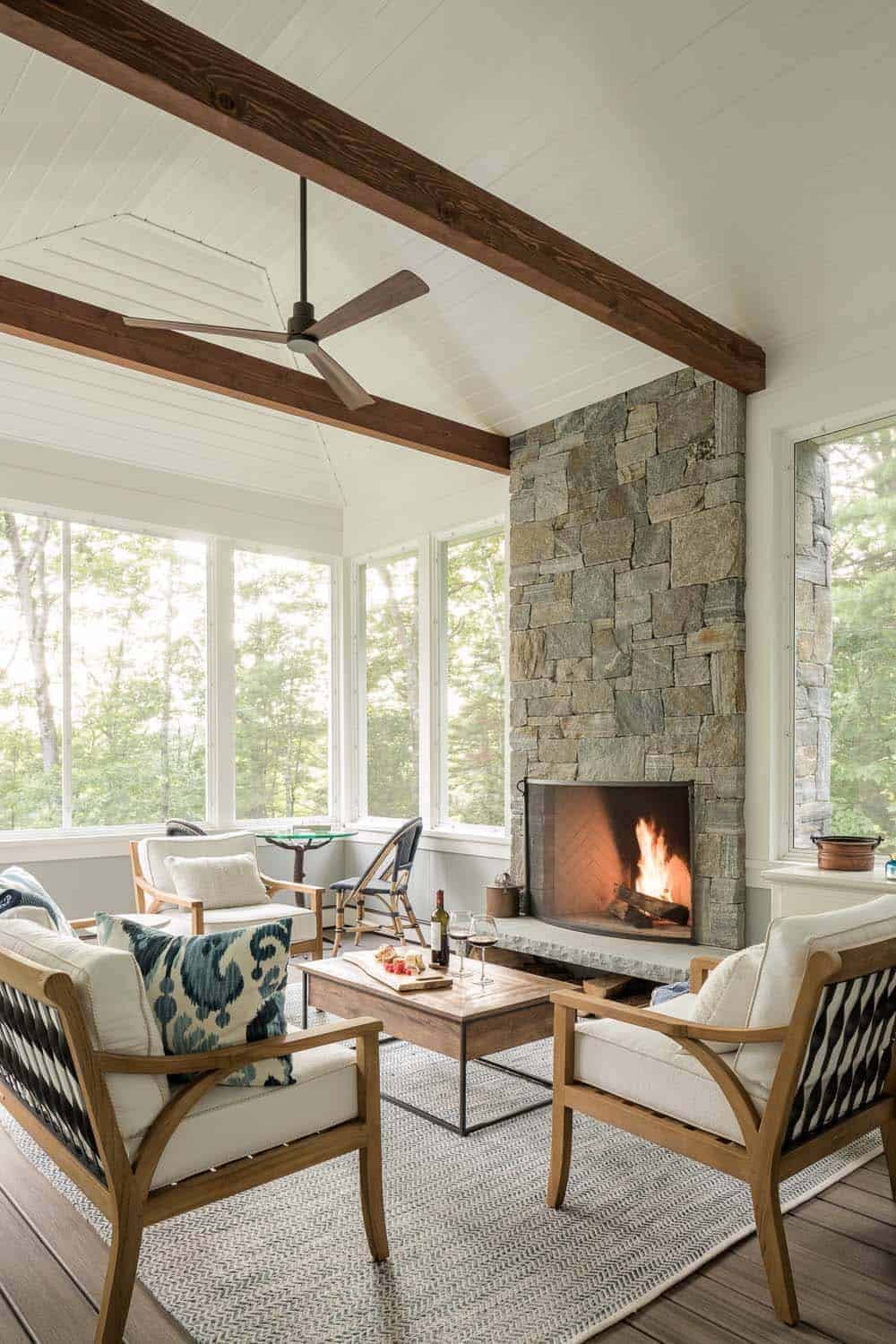 coastal style living room with large windows and a fireplace