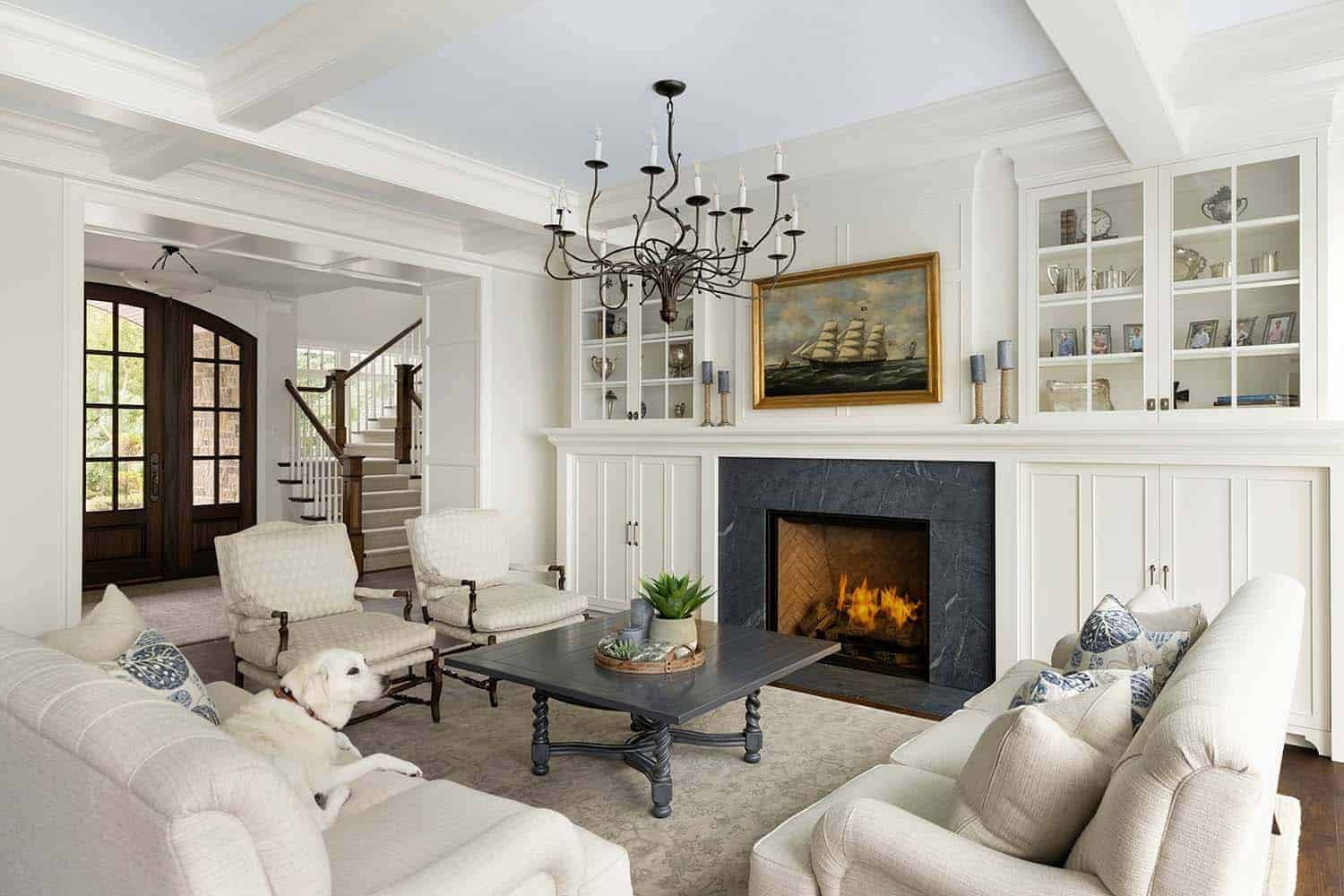 coastal style living room with a white interior and a a cozy fireplace