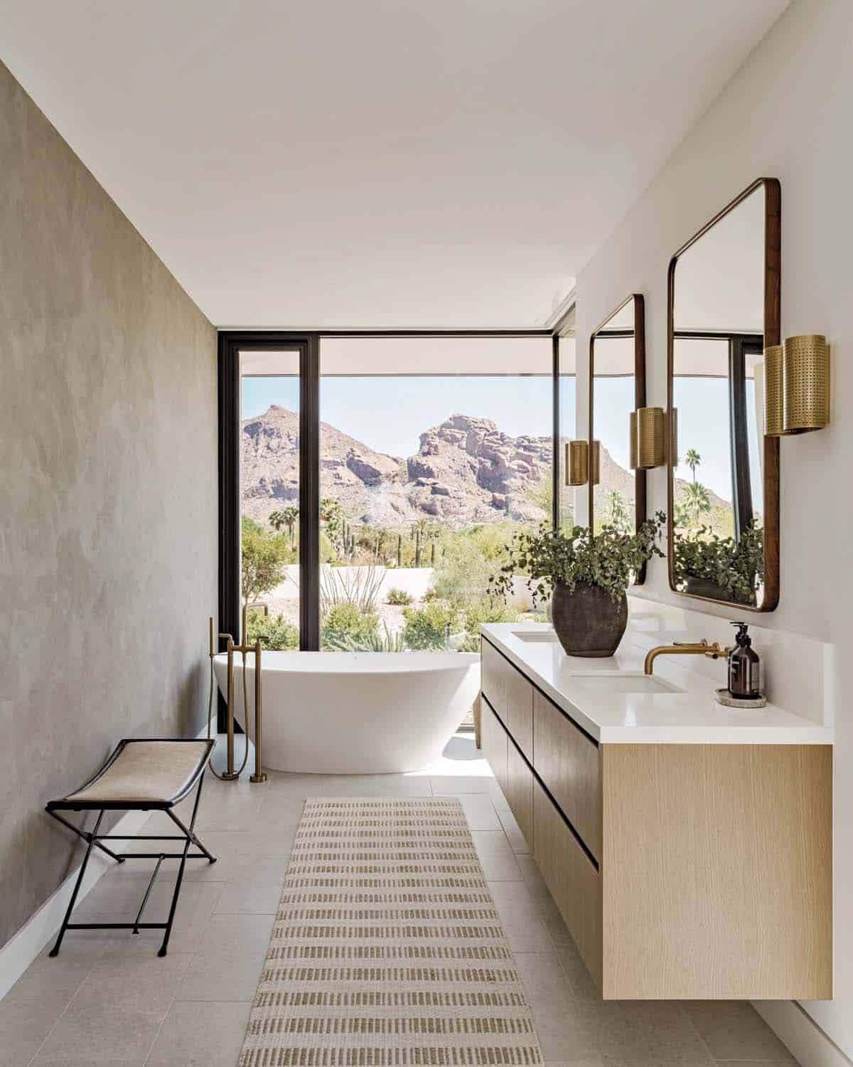 contemporary bathroom with a vanity and freestanding tub with a large window