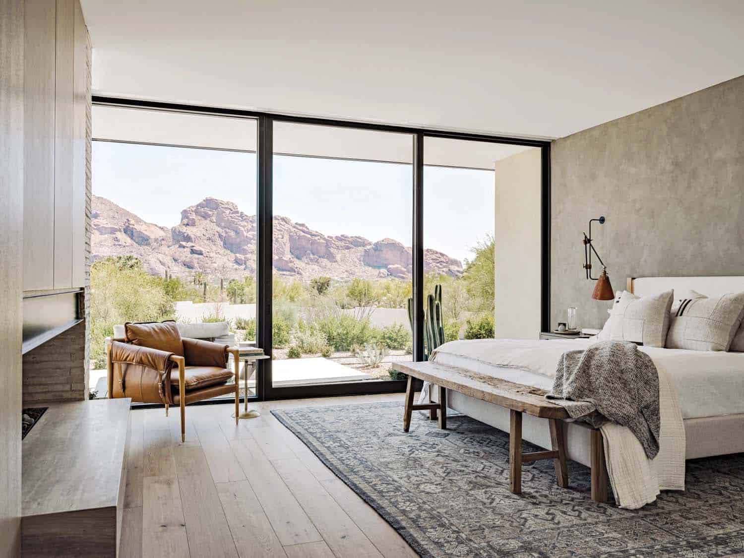 contemporary bedroom with a large window and desert views