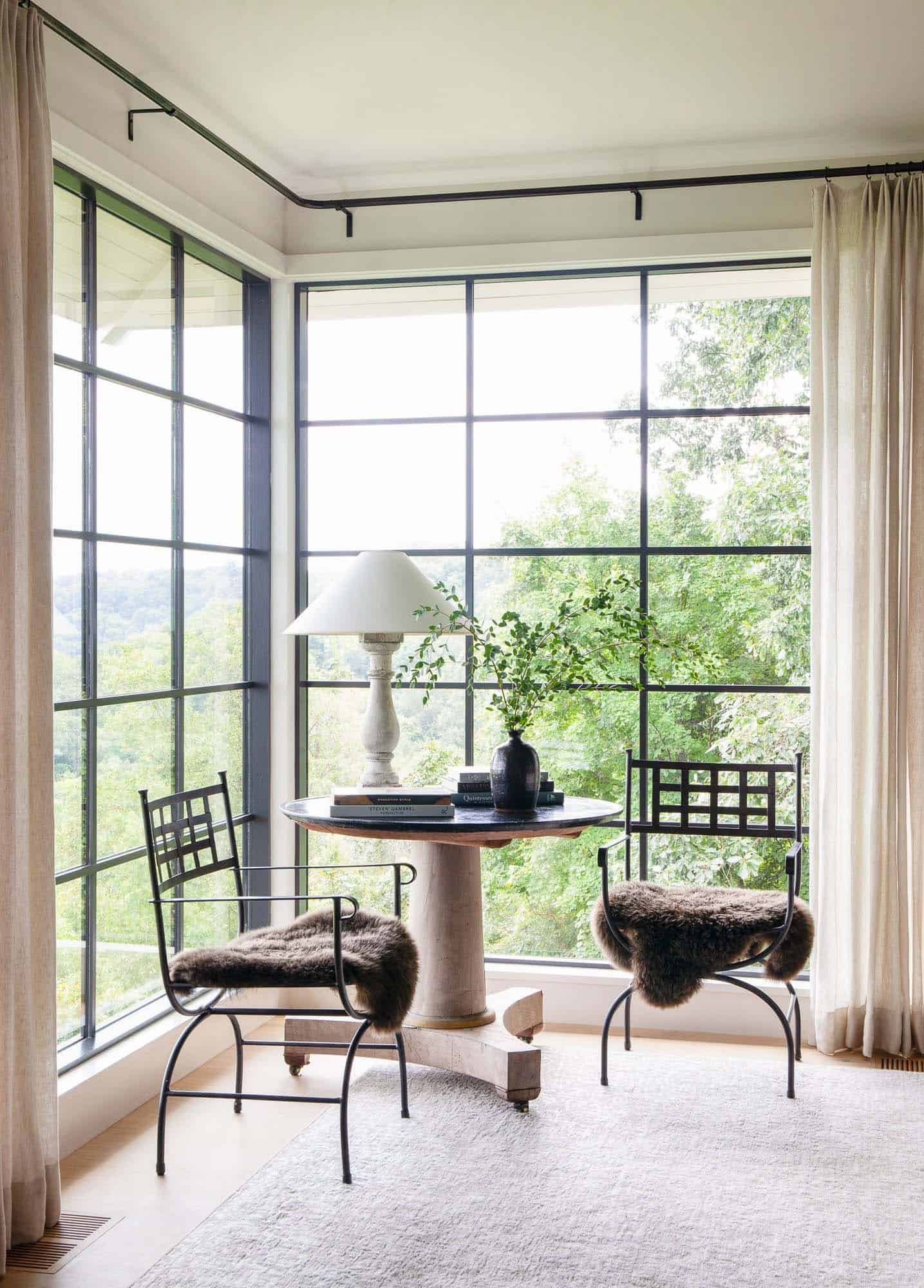 contemporary bistro set in front of large corner window