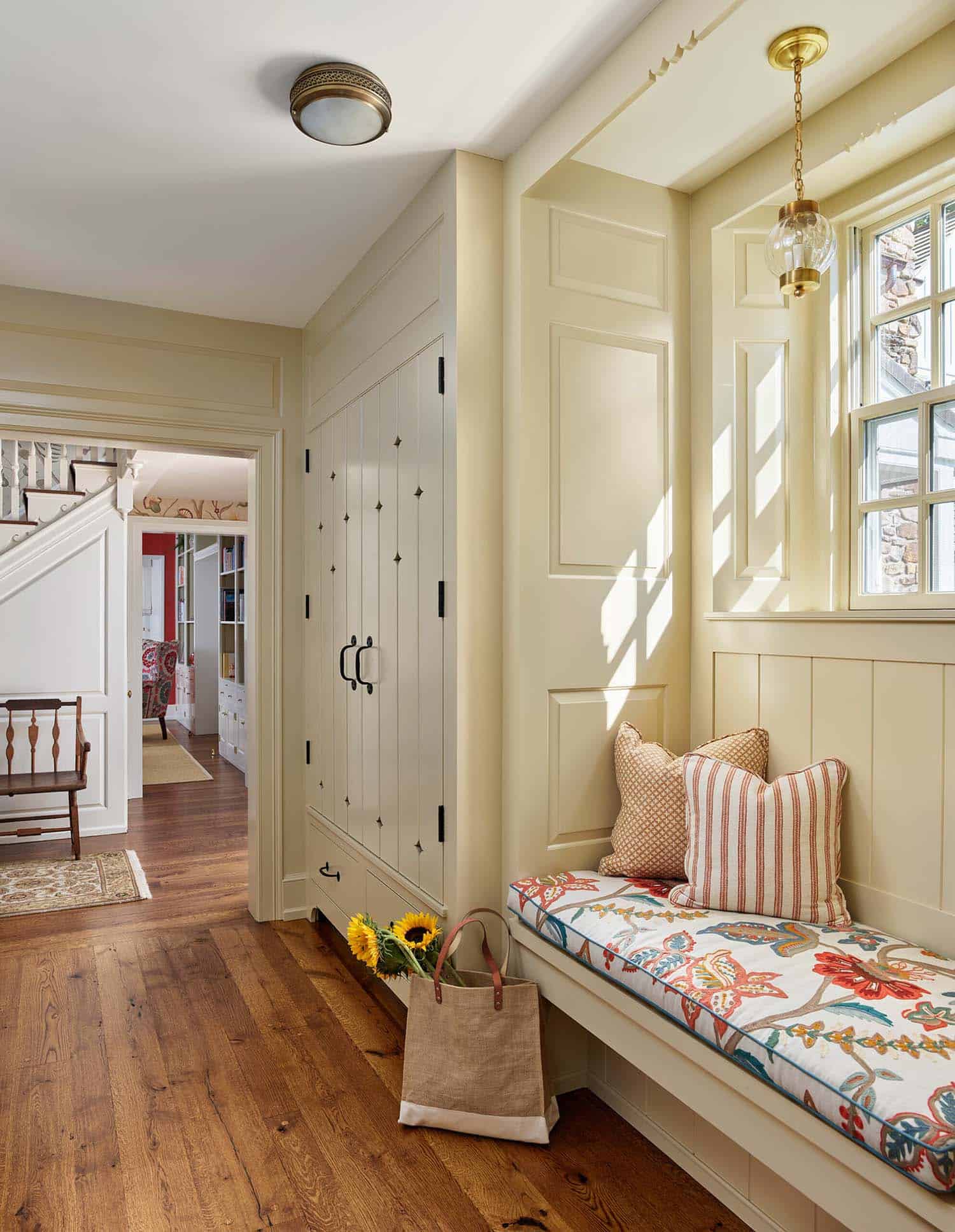 farmhouse mudroom entry with a bench seat and window