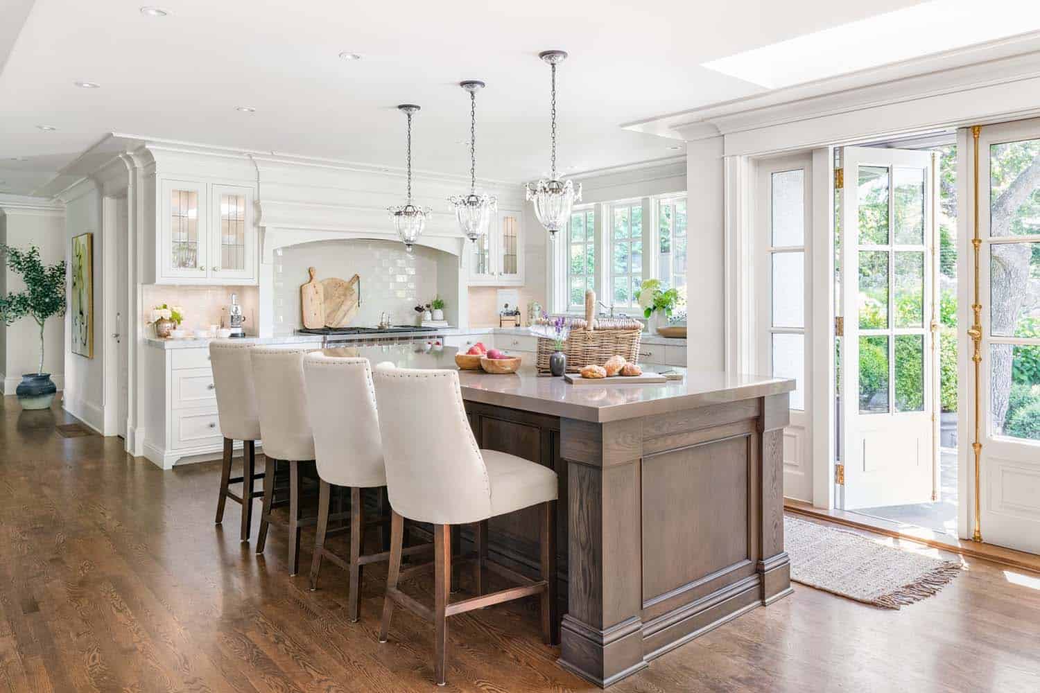 traditional kitchen with a brown stained island and white perimeter cabinets