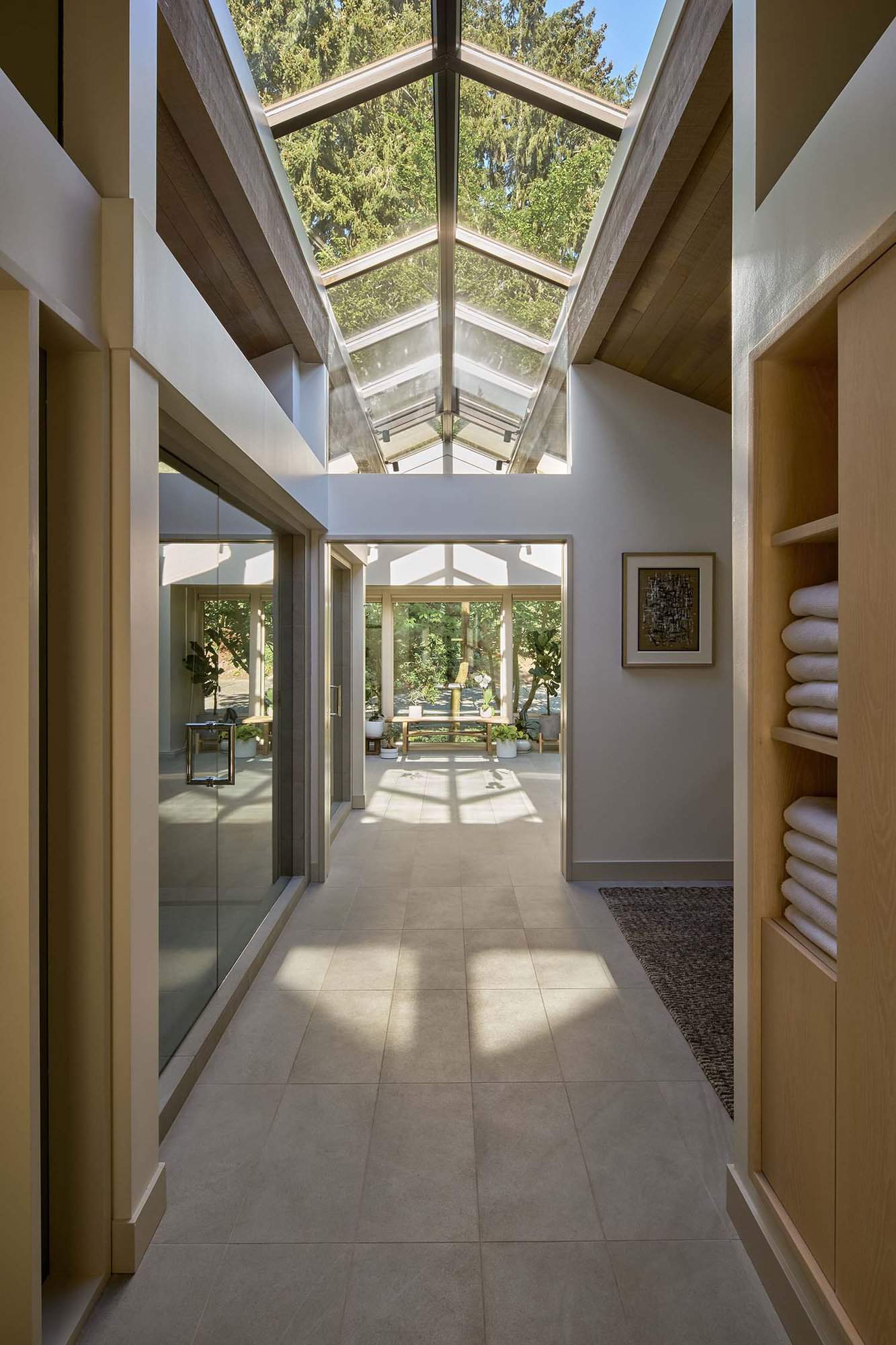 midcentury modern bedroom hallway leading into the bathroom with tall ceilings and a long skylight