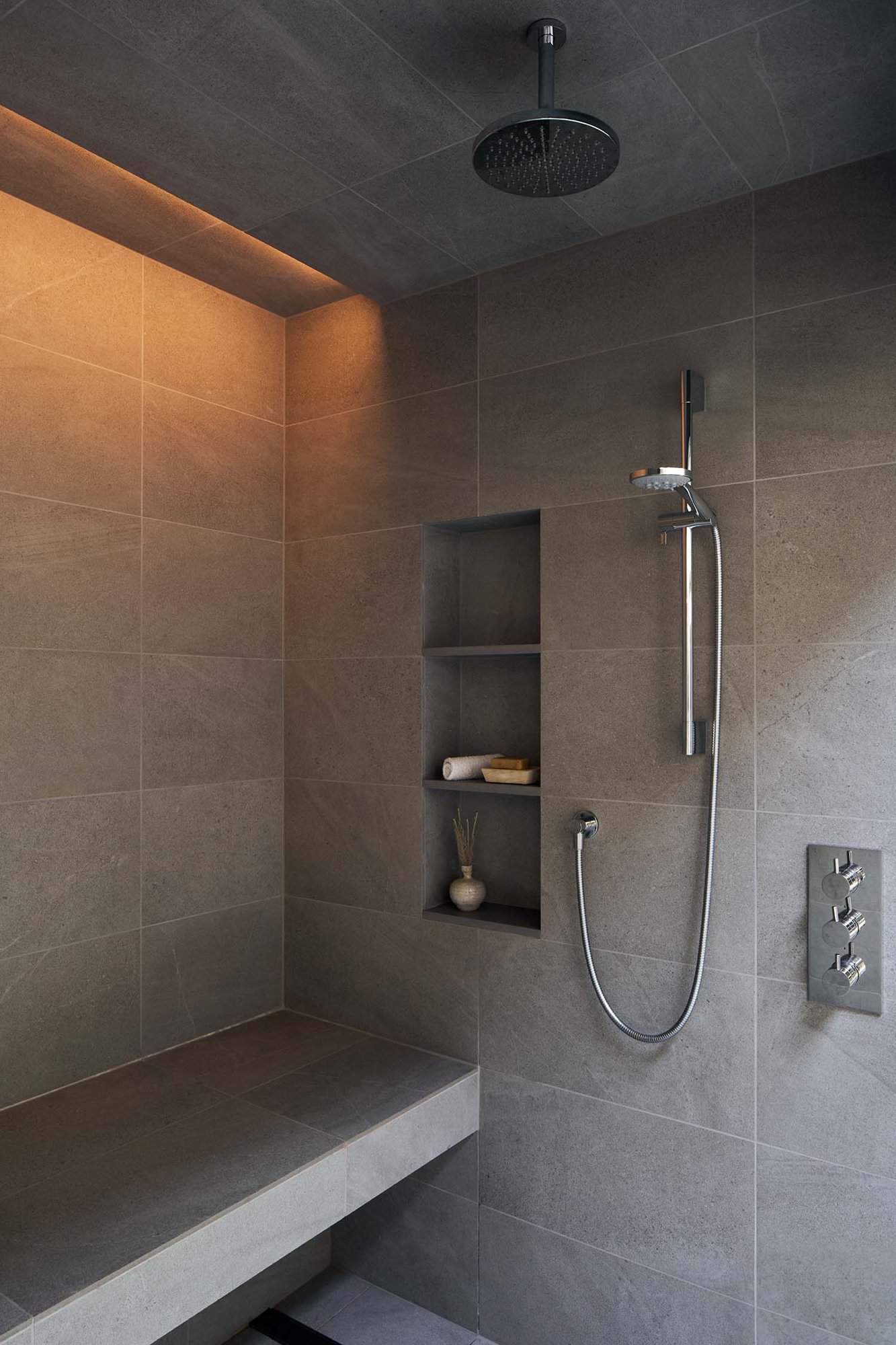 modern bathroom shower with a built-in bench
