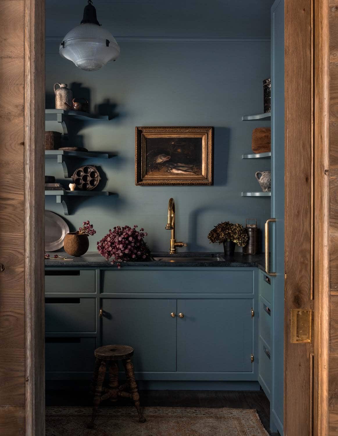 rustic walk-in pantry with blue cabinets
