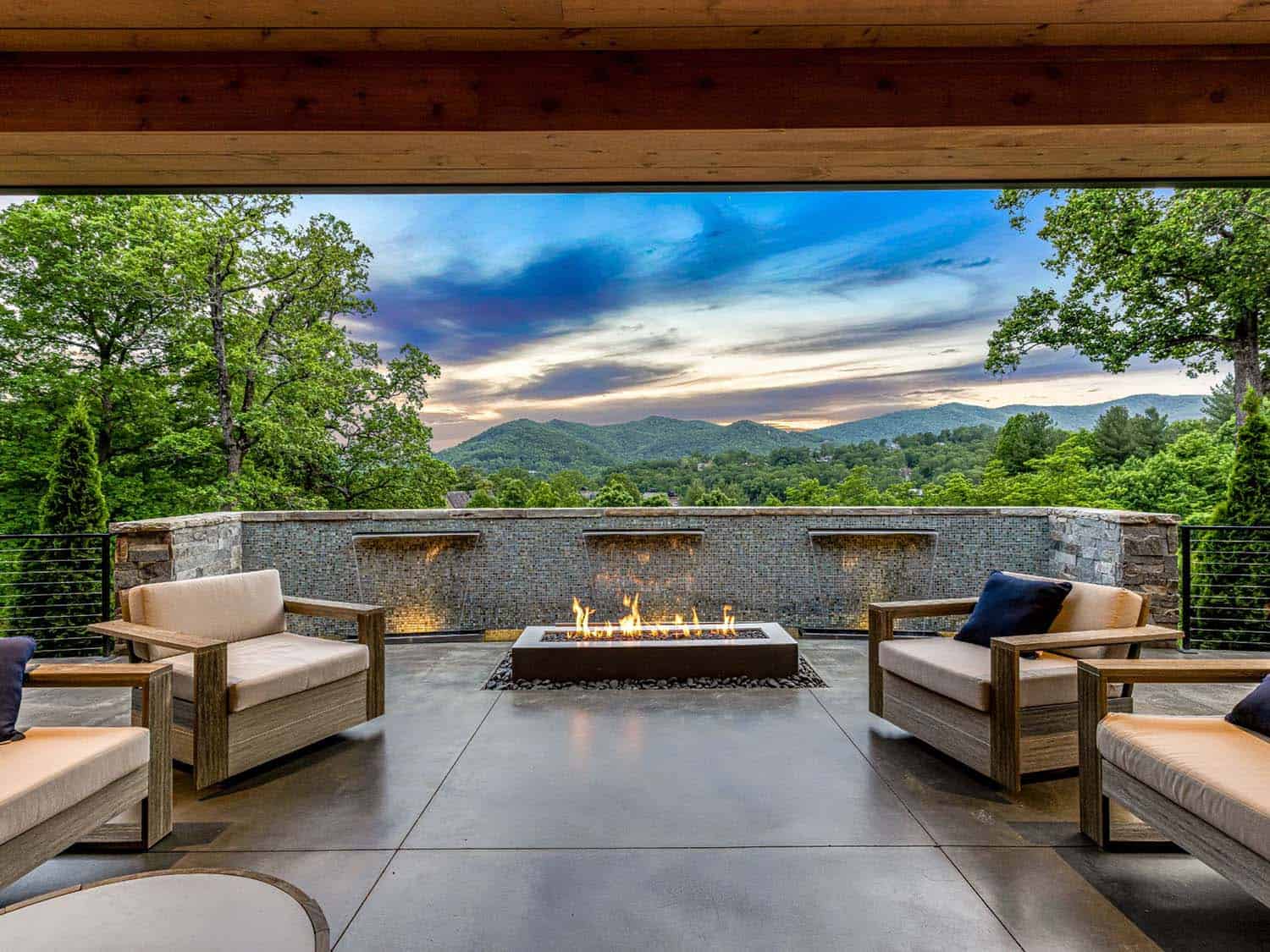 modern patio with a fire pit and water feature