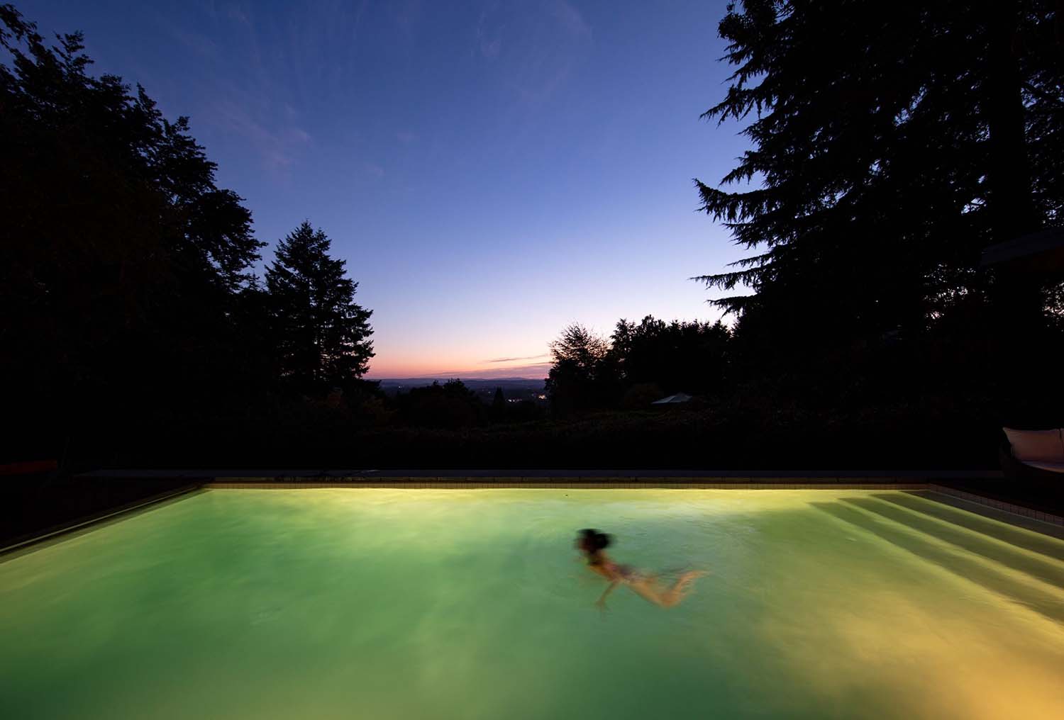 midcentury modern house swimming pool at dusk