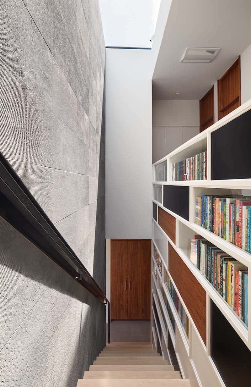 modern staircase with a bookshelf