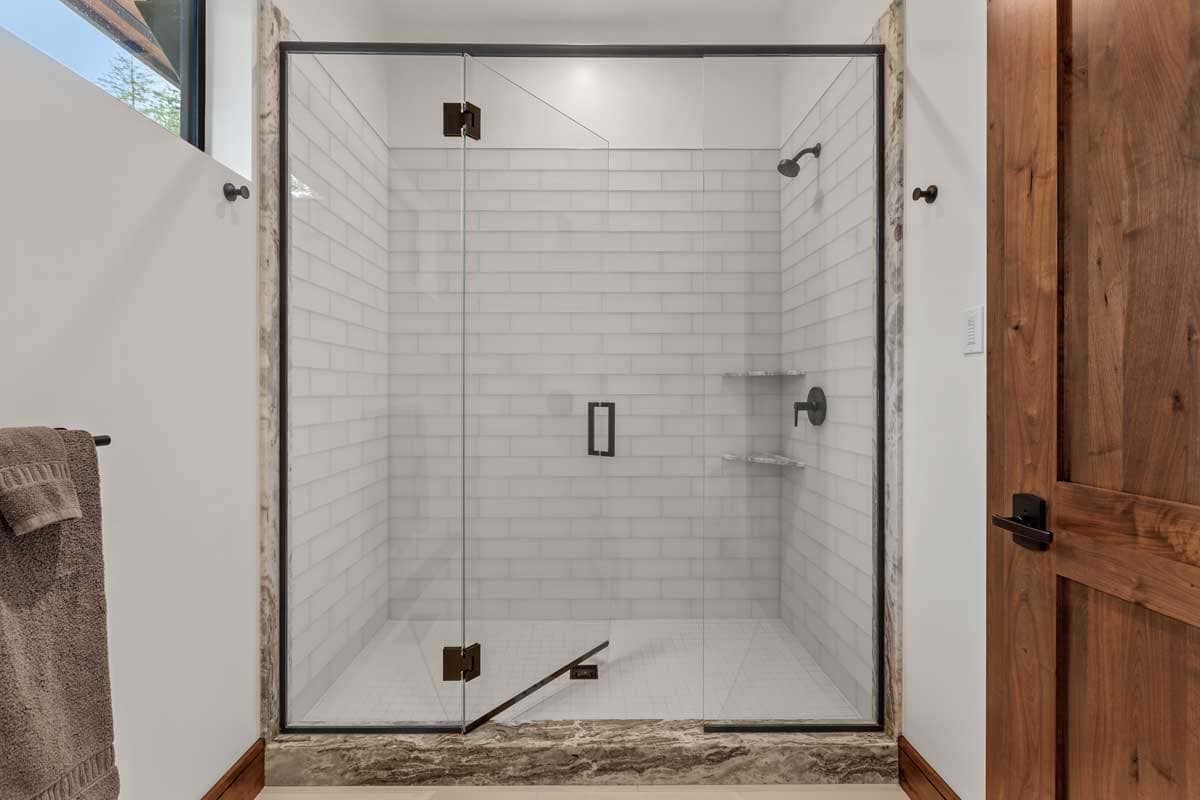 modern walk-in shower with white tiles