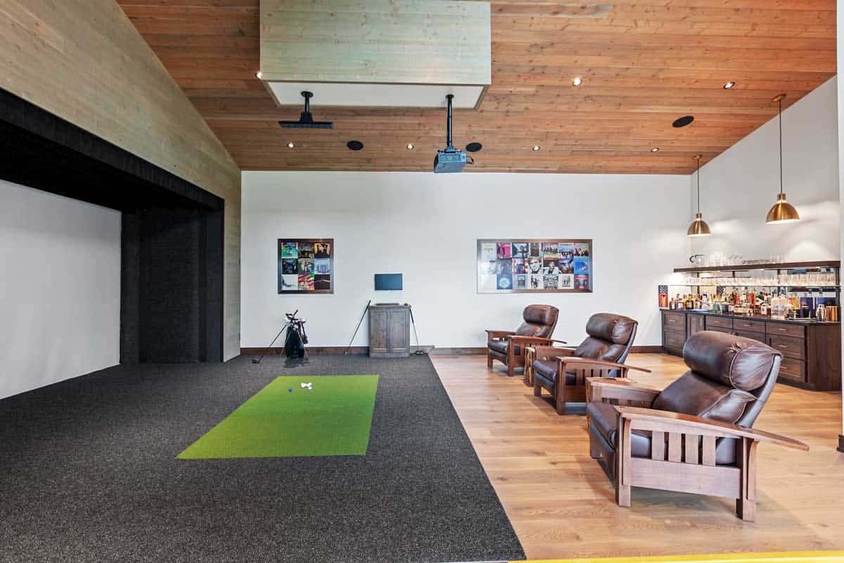 modern entertainment room with a golf simulator