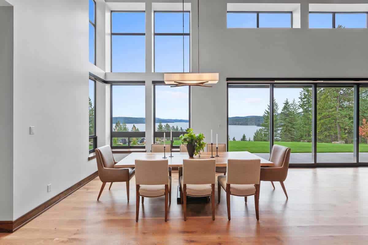 modern elegant dining room with large windows and lake views
