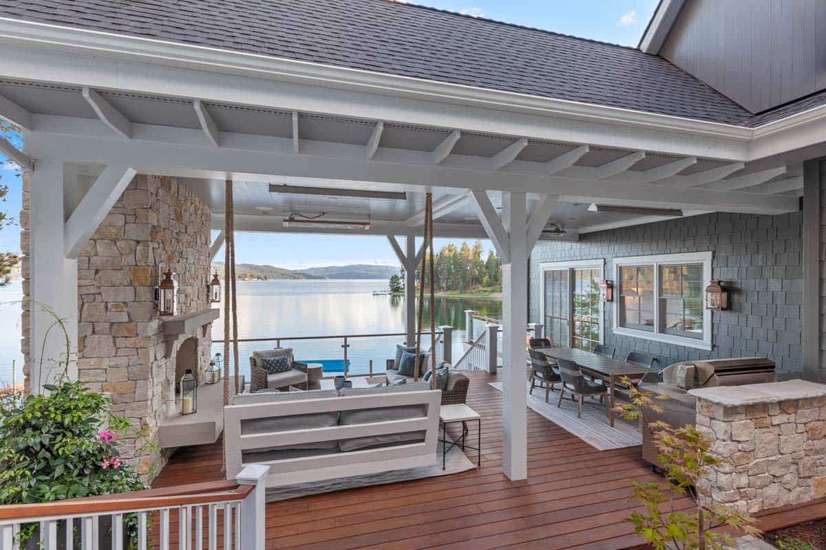 modern lake house outdoor covered patio with a hanging swing