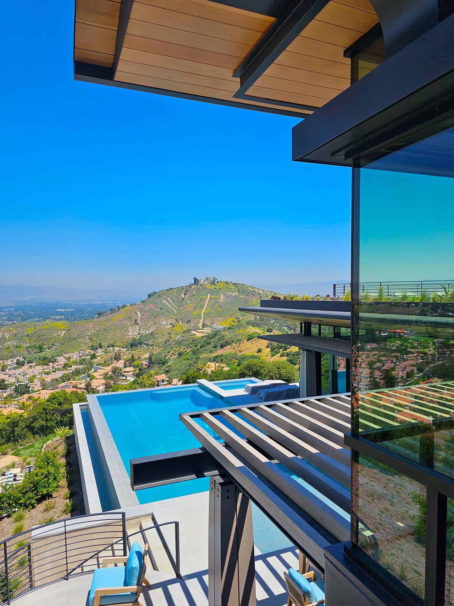 modern hilltop house exterior with a view of the pool