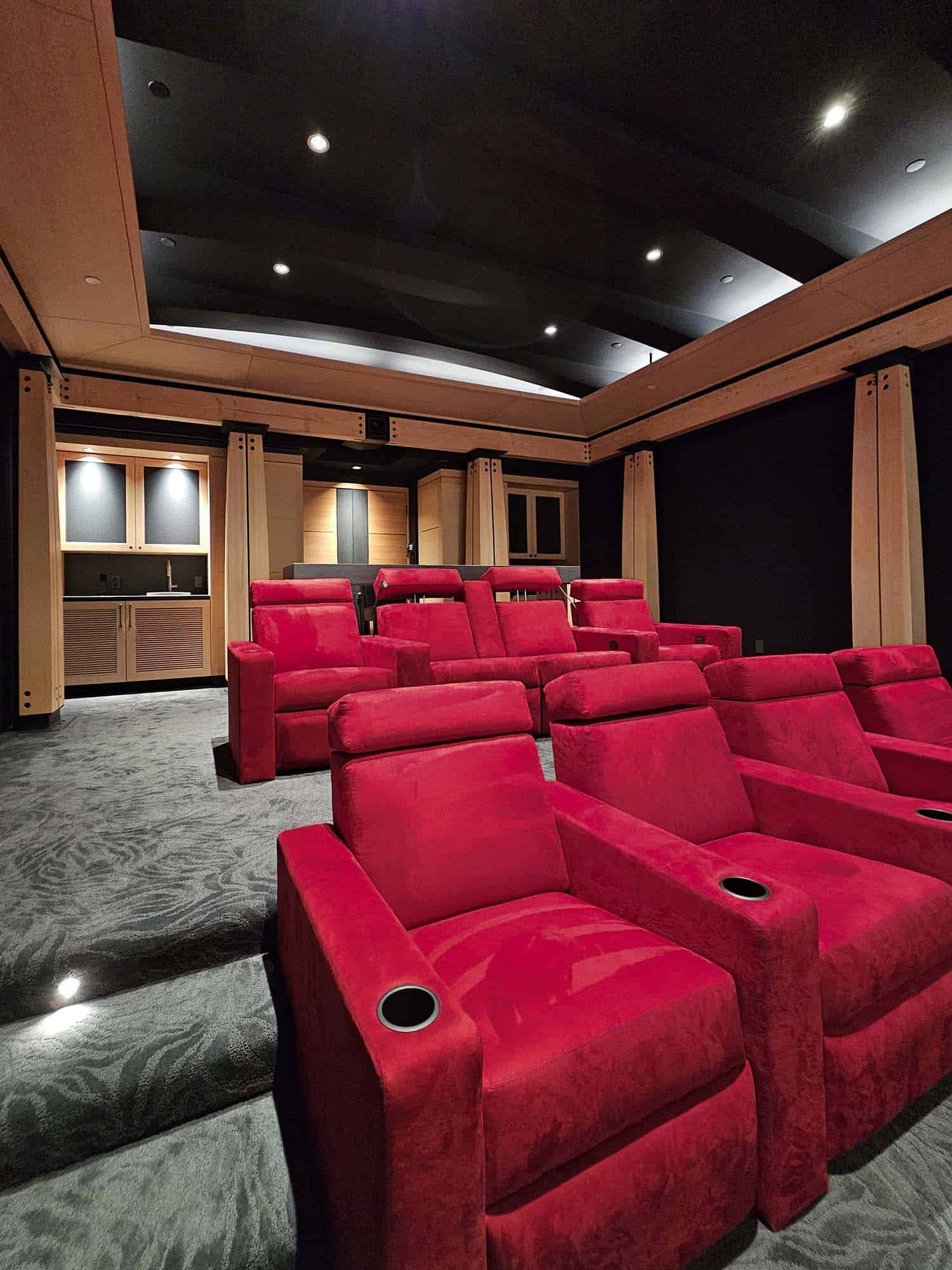 modern home theater with red theater chairs