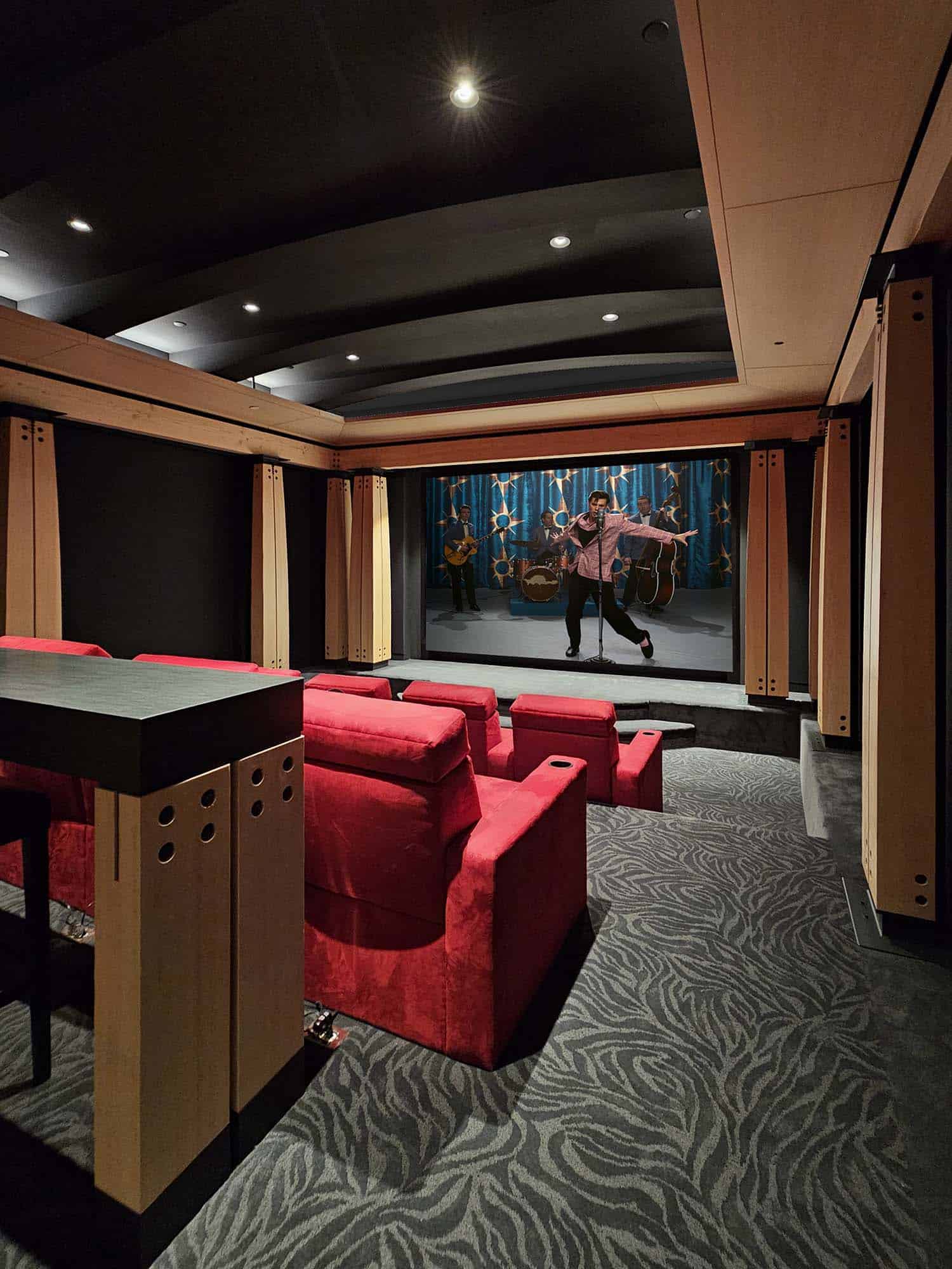modern home theater with red theater chairs