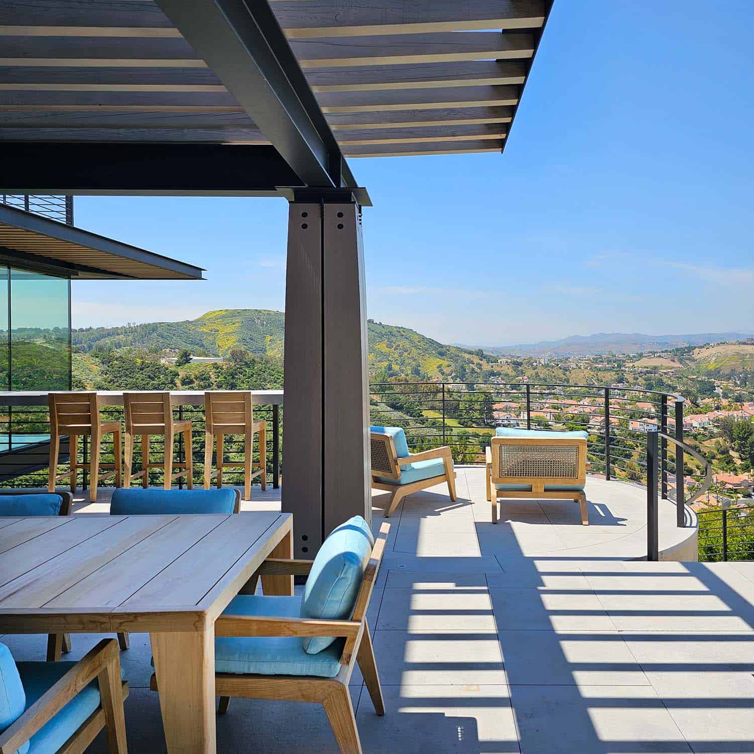 modern hilltop house patio with outdoor dining furniture