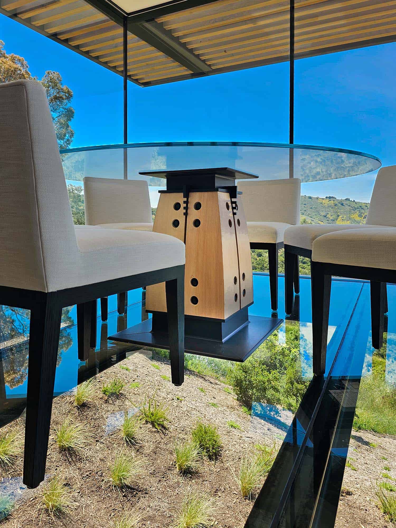 modern dining room with a glass floor cantilevering over the hillside