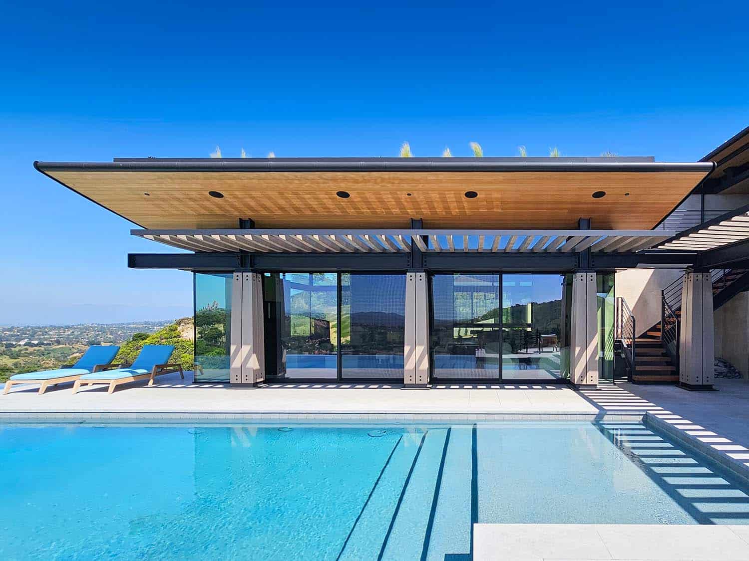 modern hilltop house patio with a pool
