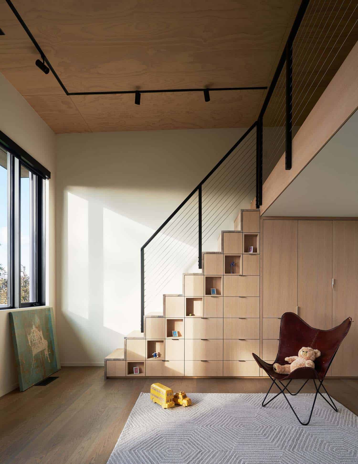 modern playroom with a staircase and integrated storage