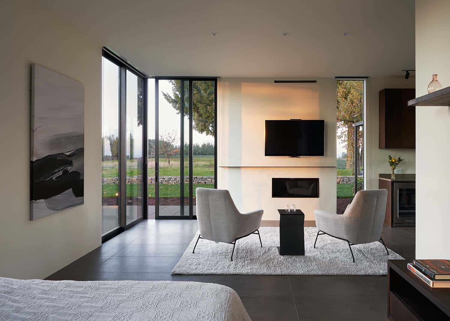 modern bedroom with a sitting area and fireplace