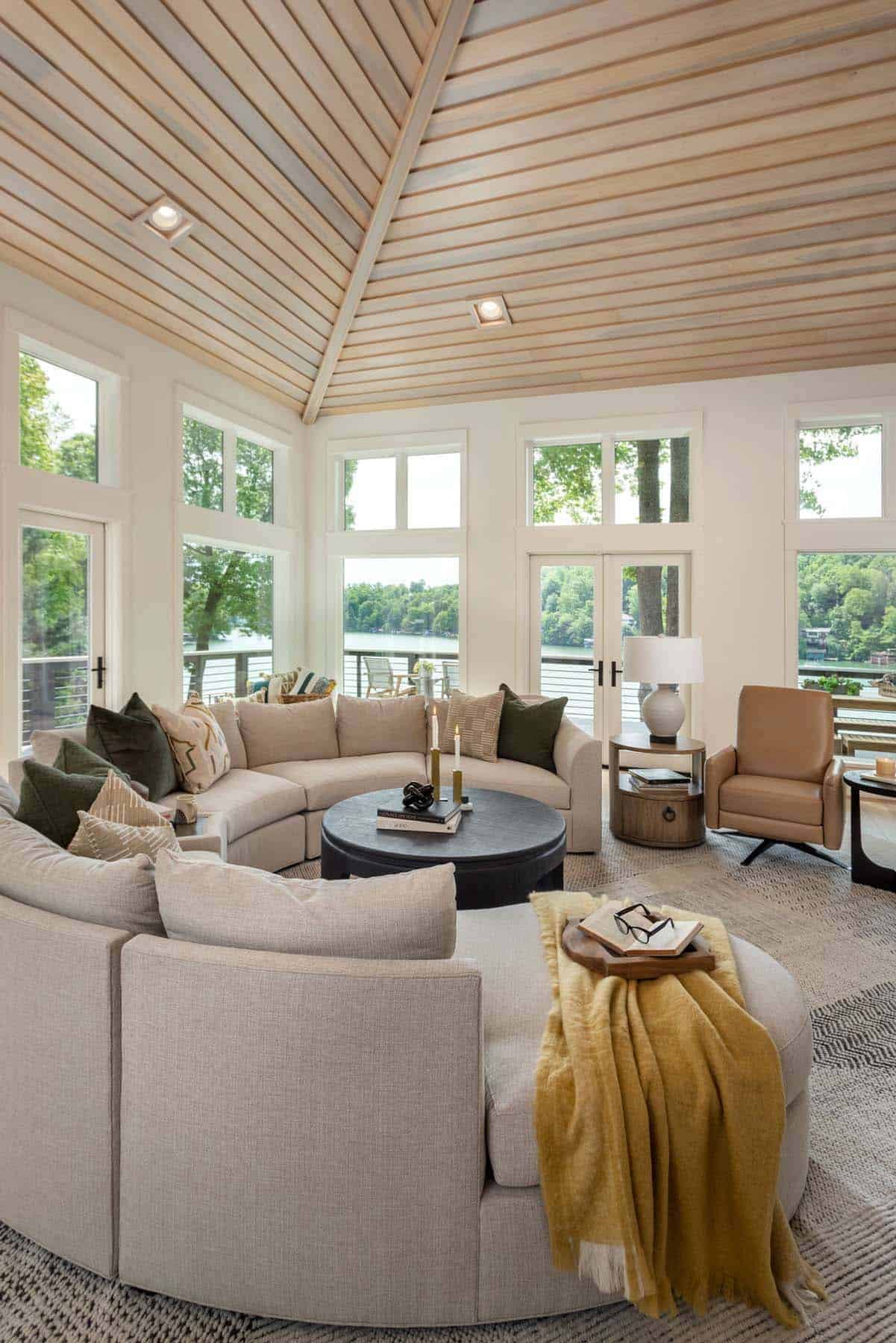 modern lake house living room with a circular sofa