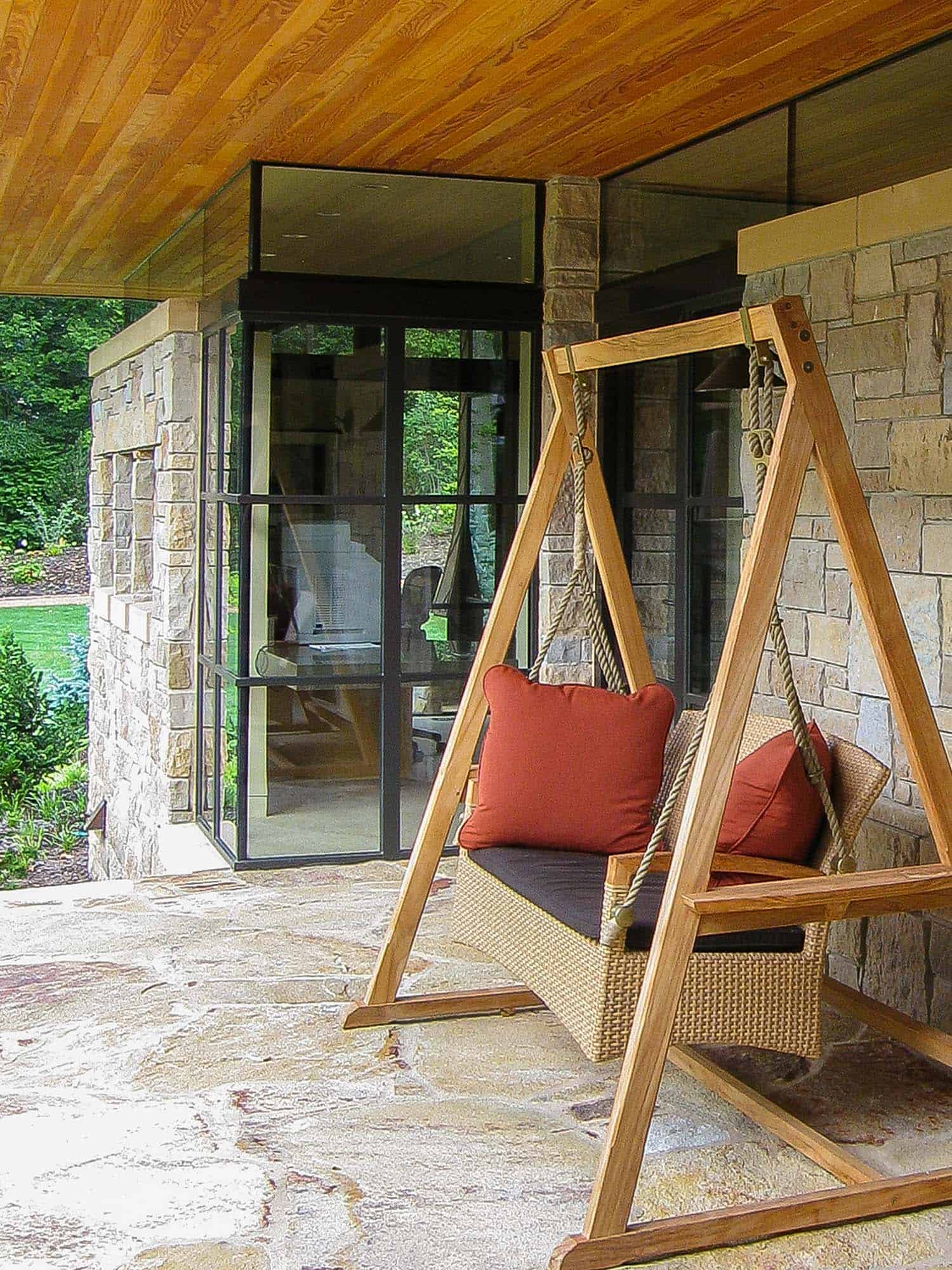 modern cottage exterior with a porch swing