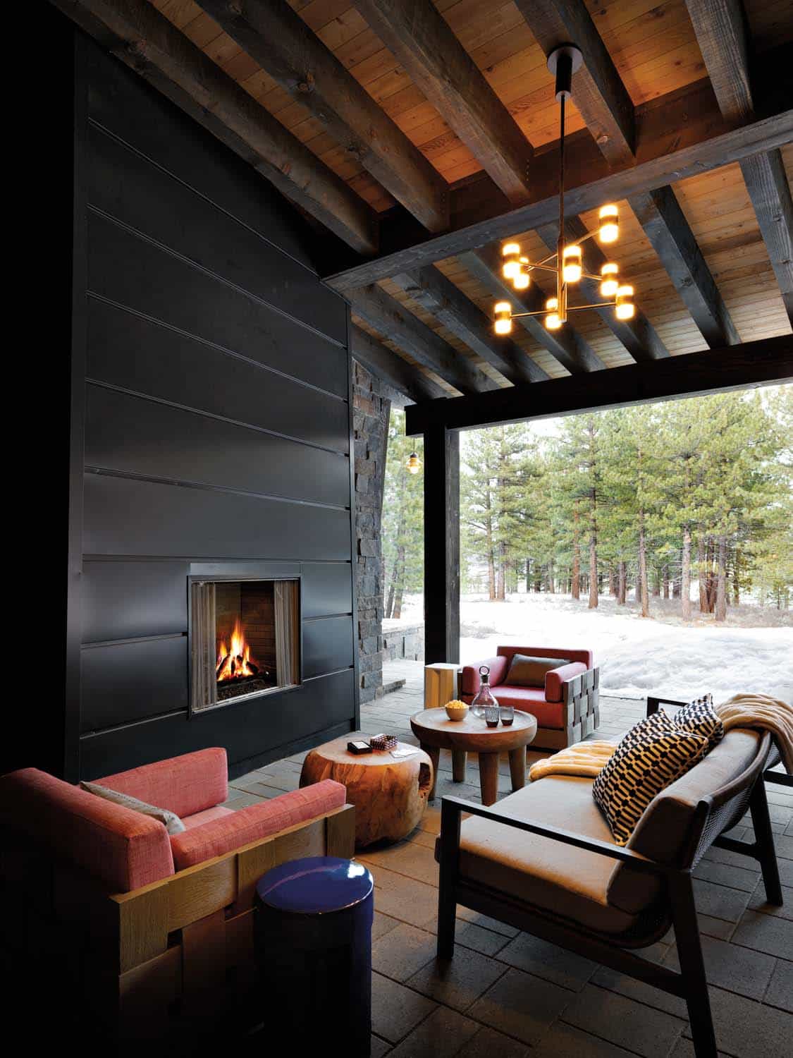 modern covered porch with a fireplace and outdoor furniture 