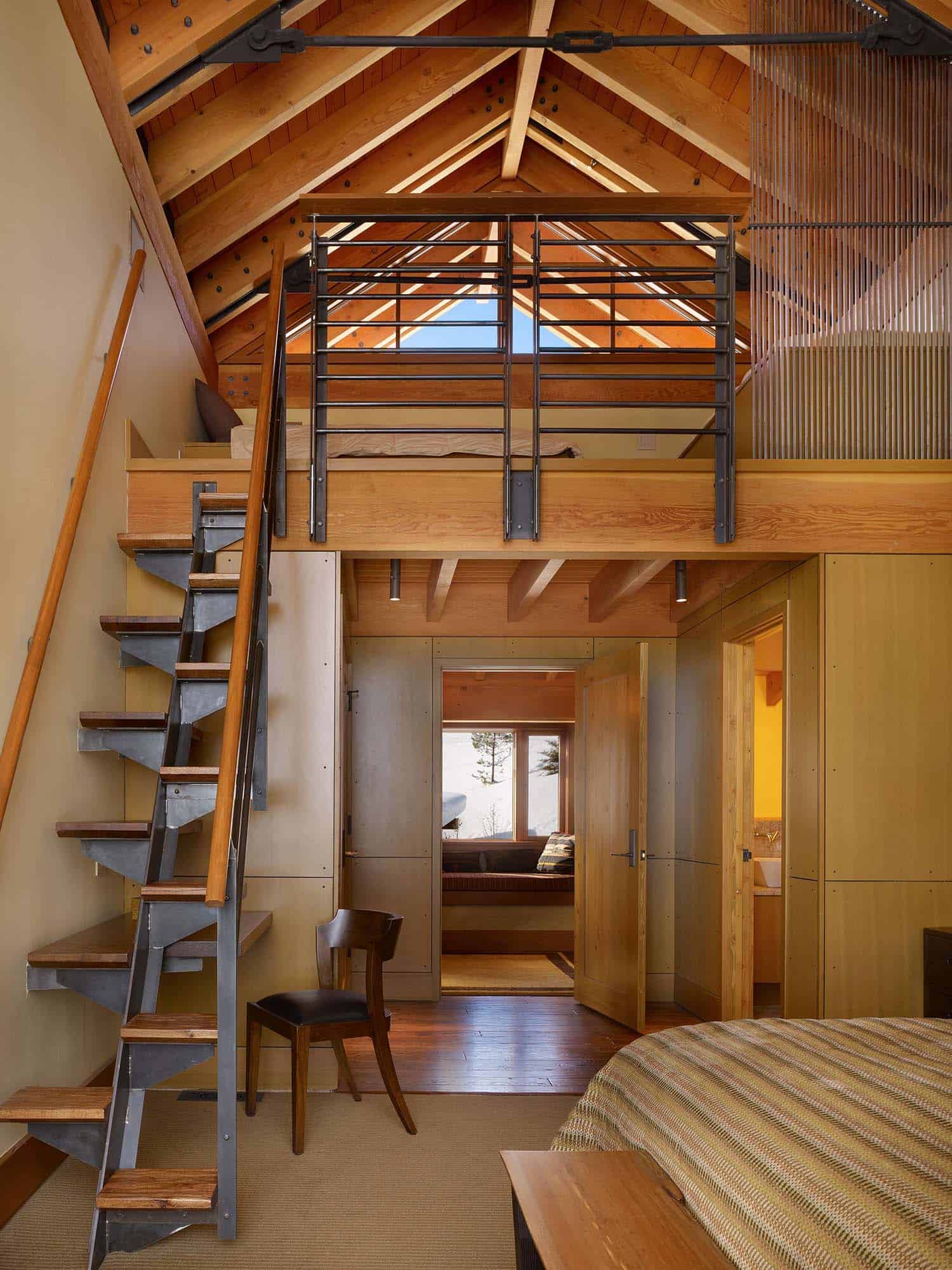modern rustic bedroom with a staircase leading to a loft