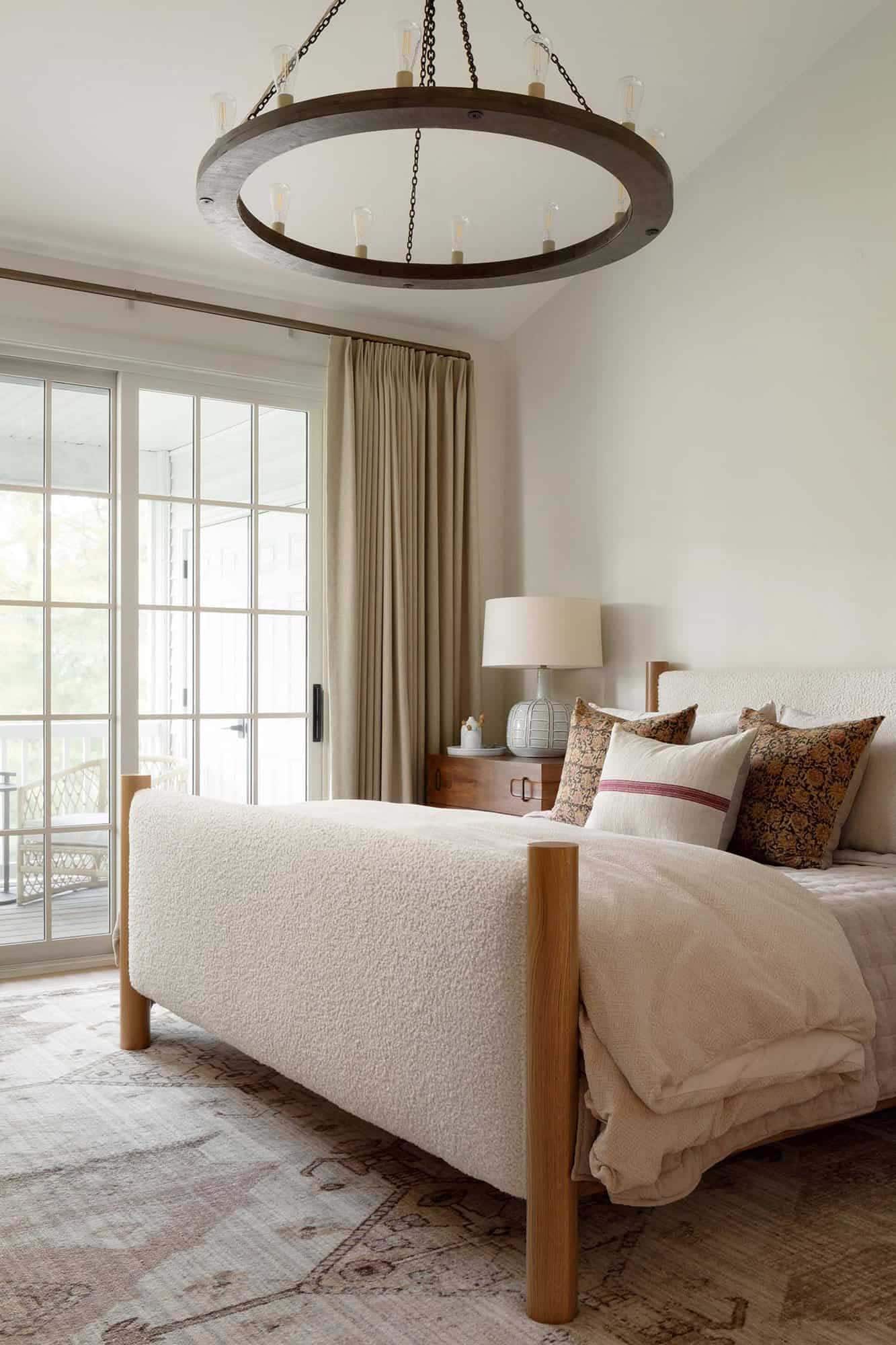 modern bedroom with a large chandelier and French doors