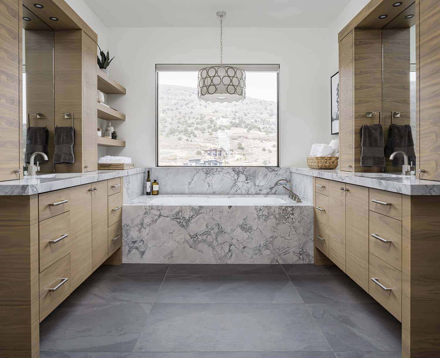 mountain modern style bathroom with dual vanities and a marble tub