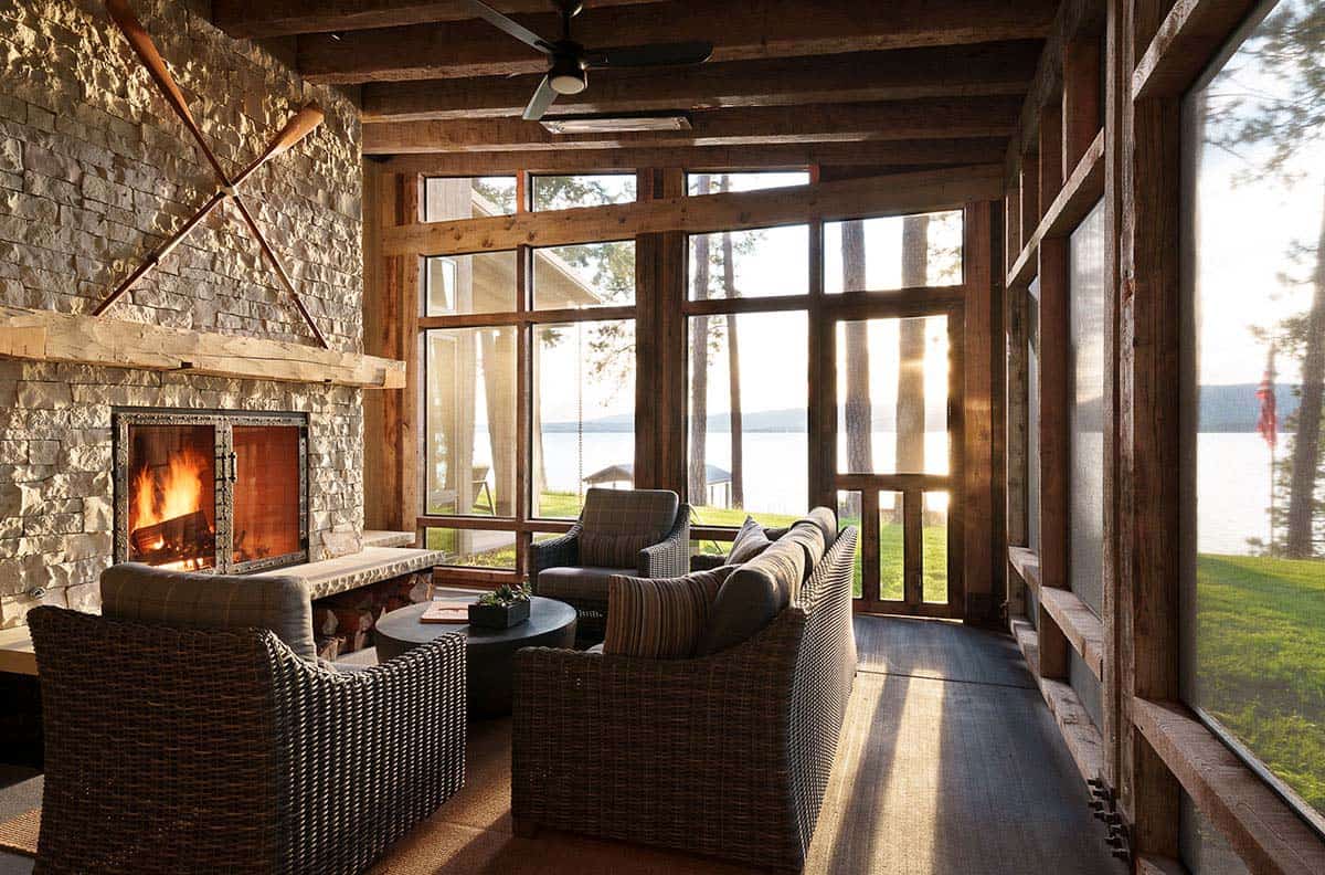 rustic modern screened porch with outdoor furniture and a fireplace