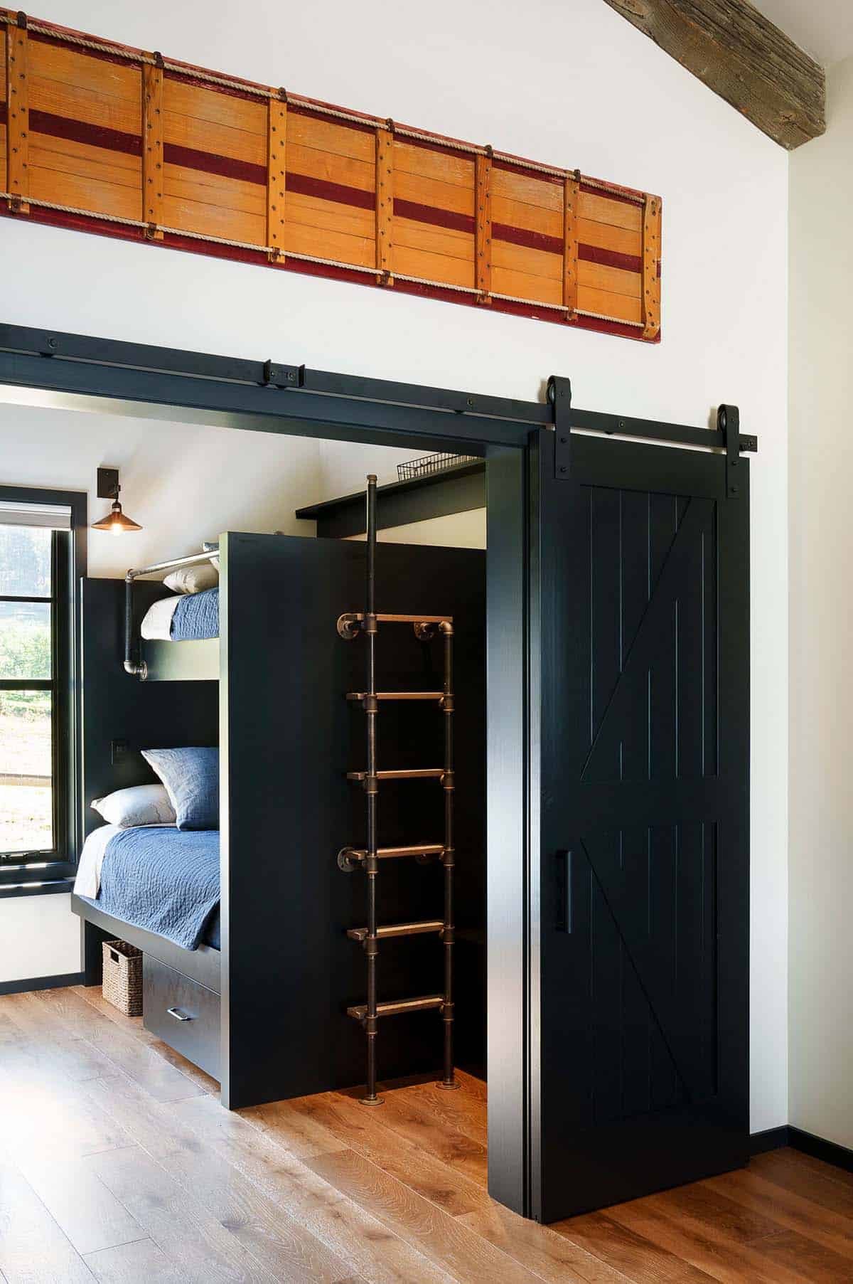 rustic modern guest house bunk bedroom with a custom metal ladder