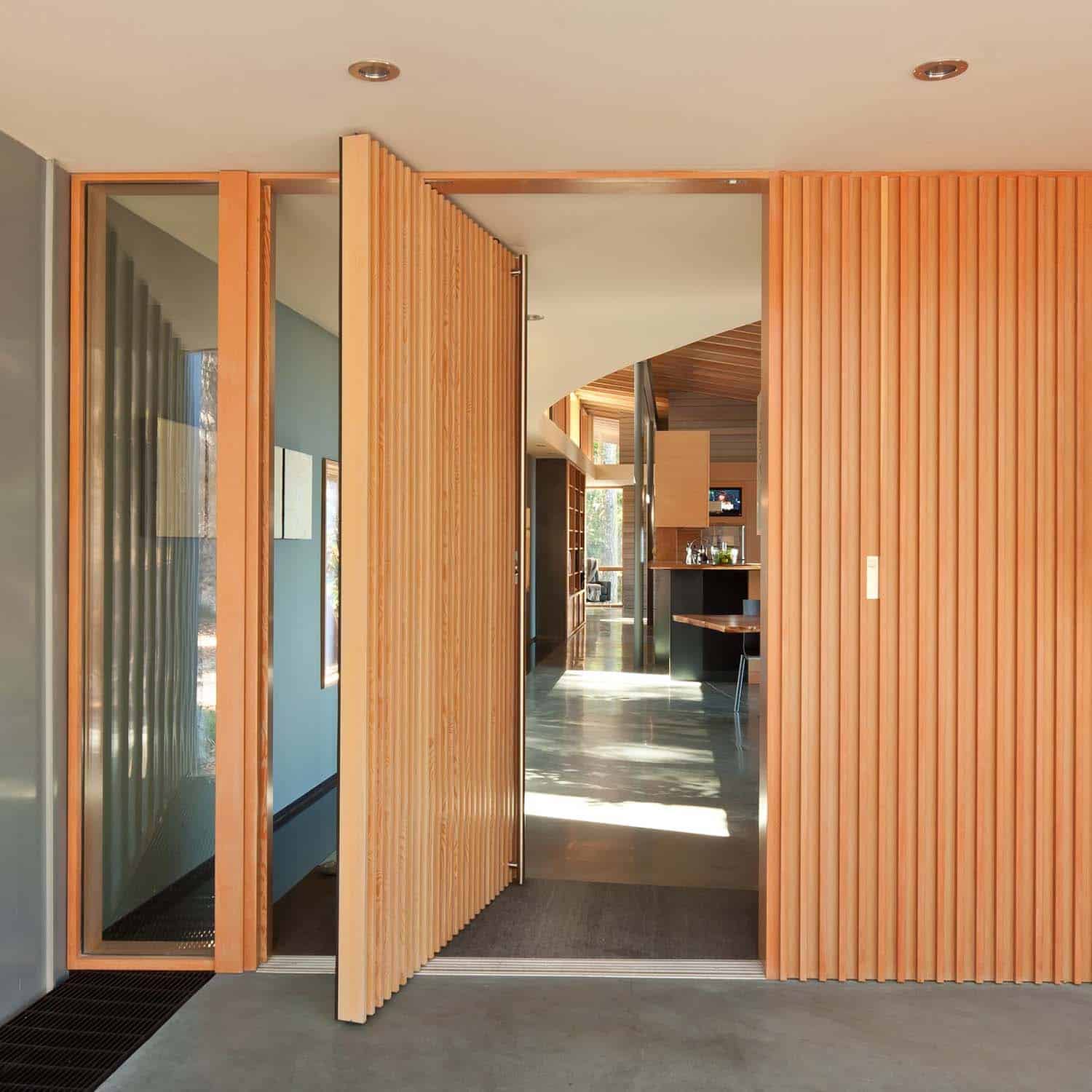 modern house exterior entry with a pivoting door