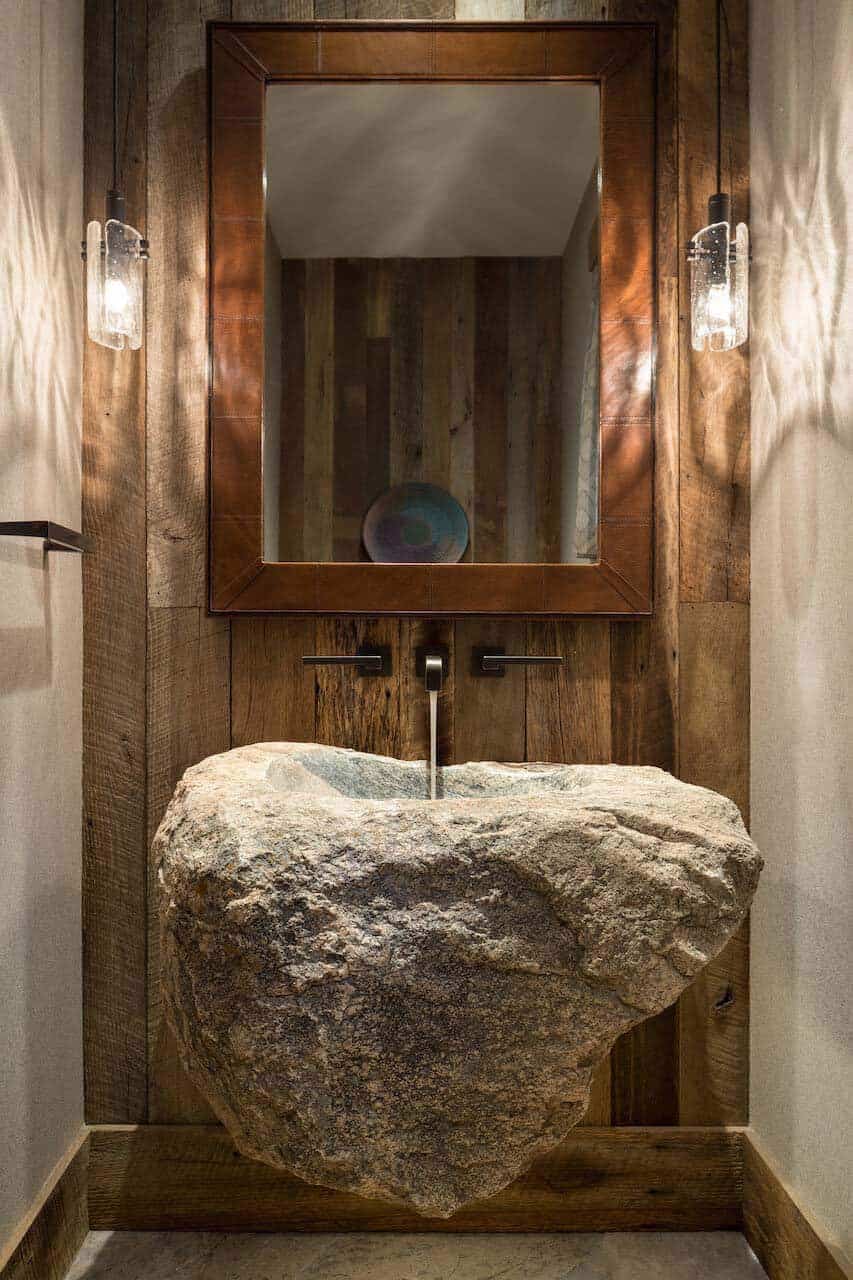 rustic powder room with a custom stone vanity
