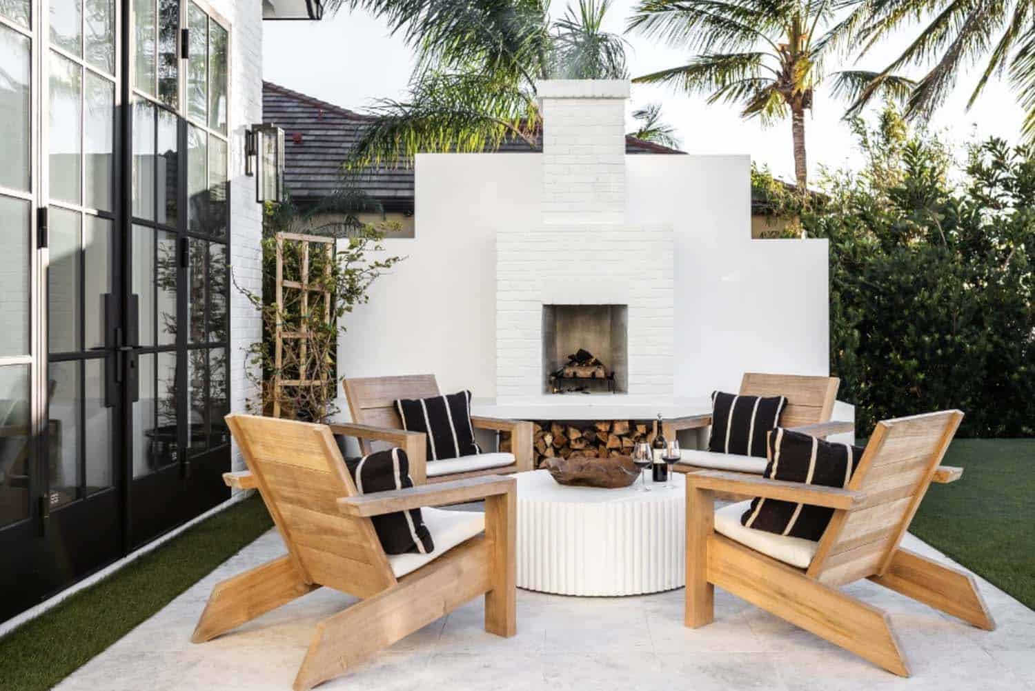 modern coastal home backyard exterior with a fireplace