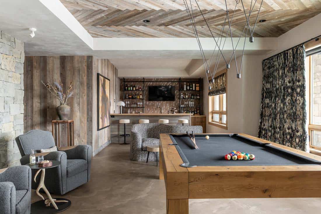 modern rustic family room with a home bar and pool table