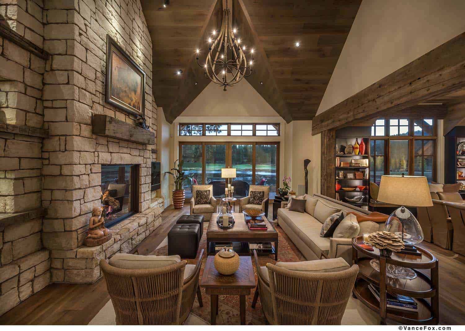 rustic living room with a fireplace and vaulted ceiling