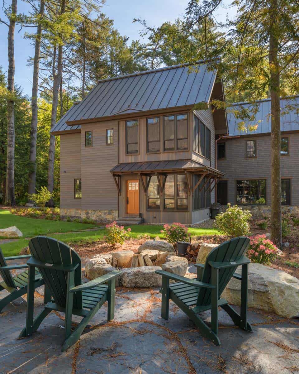 rustic lake house exterior with a fire pit and Adirondack furniture