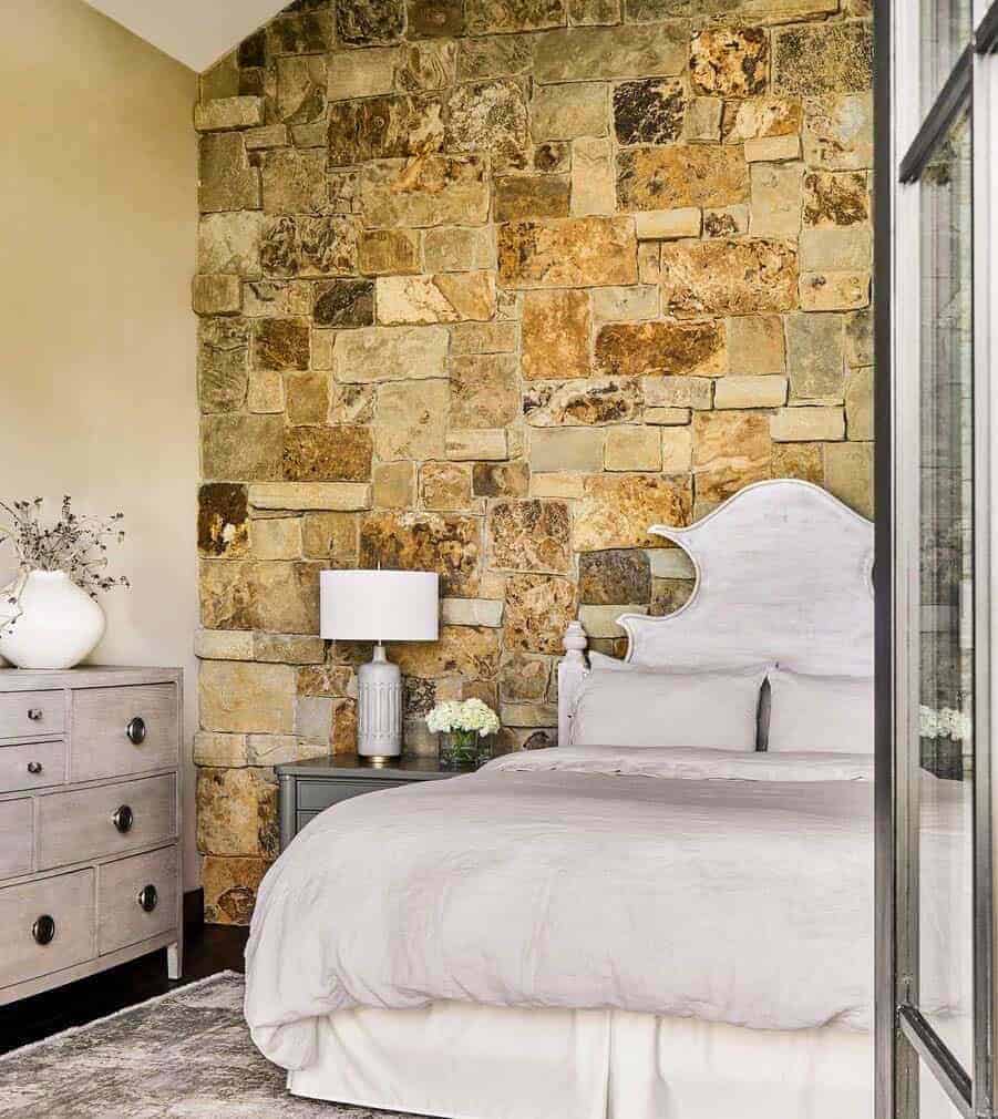 rustic mountain-style bedroom with a stone accent wall