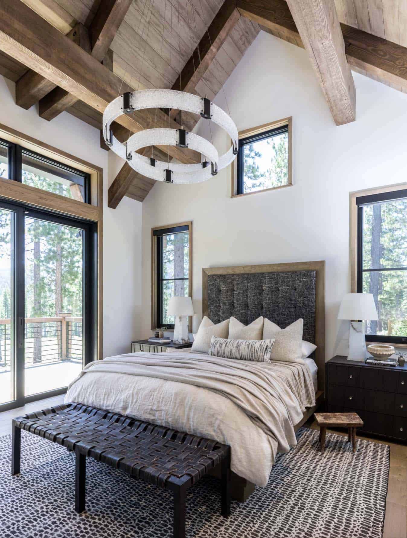 rustic mountain style bedroom with a large chandelier